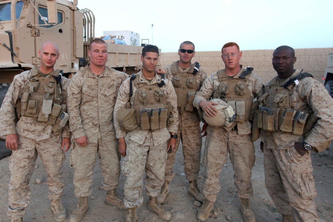 U.S. Marines from 1st Battalion 2nd Marine Regiment(1/2) pose for a group picture after a convoy from Musa Qal'eh District Center to Habib, April 2, 2010. Marines with 1/2 are conducting convoys to Combat Outpost Habib to resupply Marines operating in the area. (U.S. Marine Corps photo by Lance Cpl. Carl Payne)