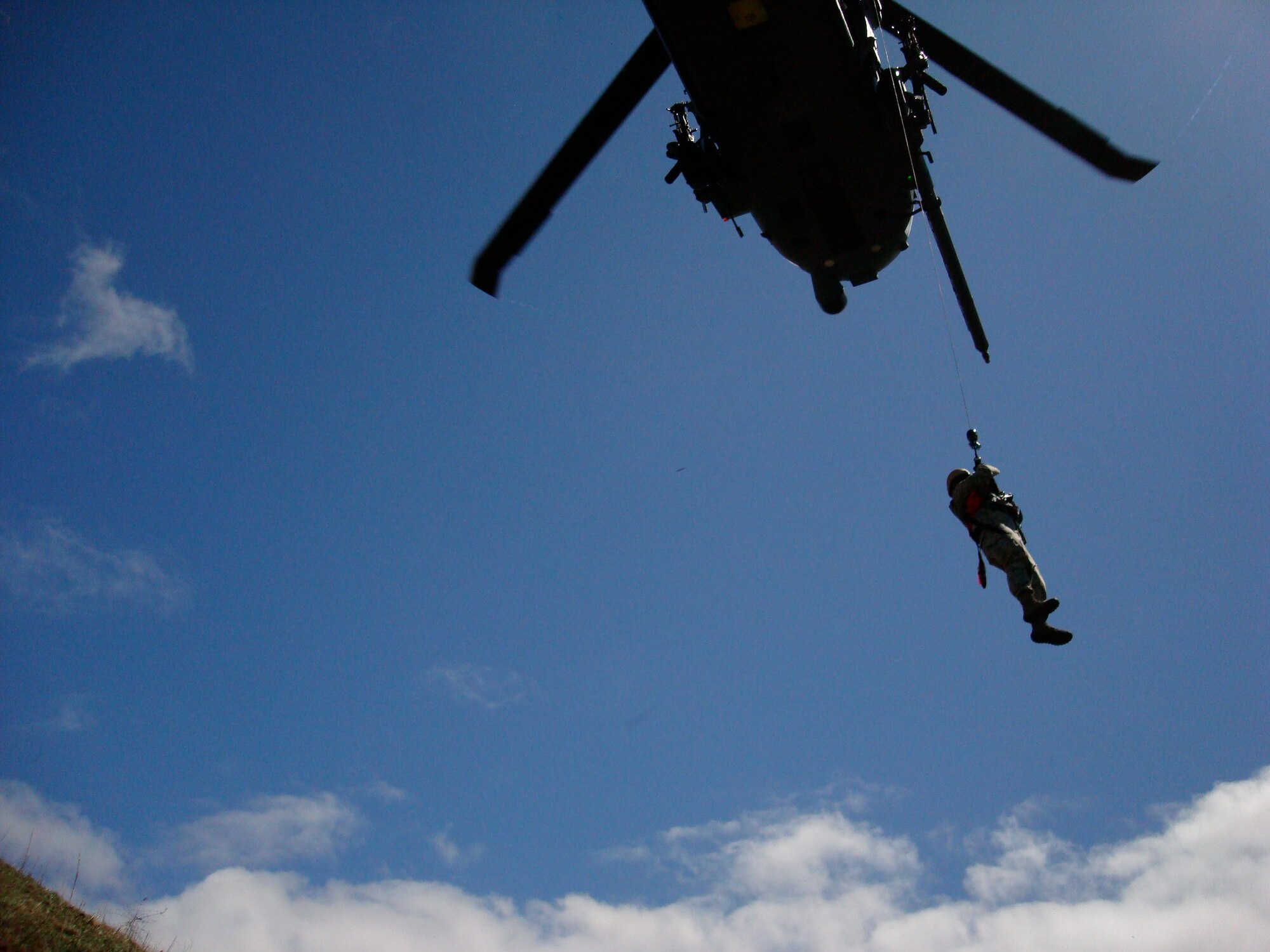 Maj. Thomas Ikehara, from the Hawaii Air Support Operations Center, under the 25th Air Support Operations Squadron, is being hosted up a Xx helicopter during a simulated downed pilot scenario as part of exercise Balikatan 2010. Balikatan is an annual exercise designed to increase interoperability between the U.S. and Philippine air forces, and exercises the two nation's ability to operate together when responding to natural disasters. (U.S. Air Force courtesy photo)