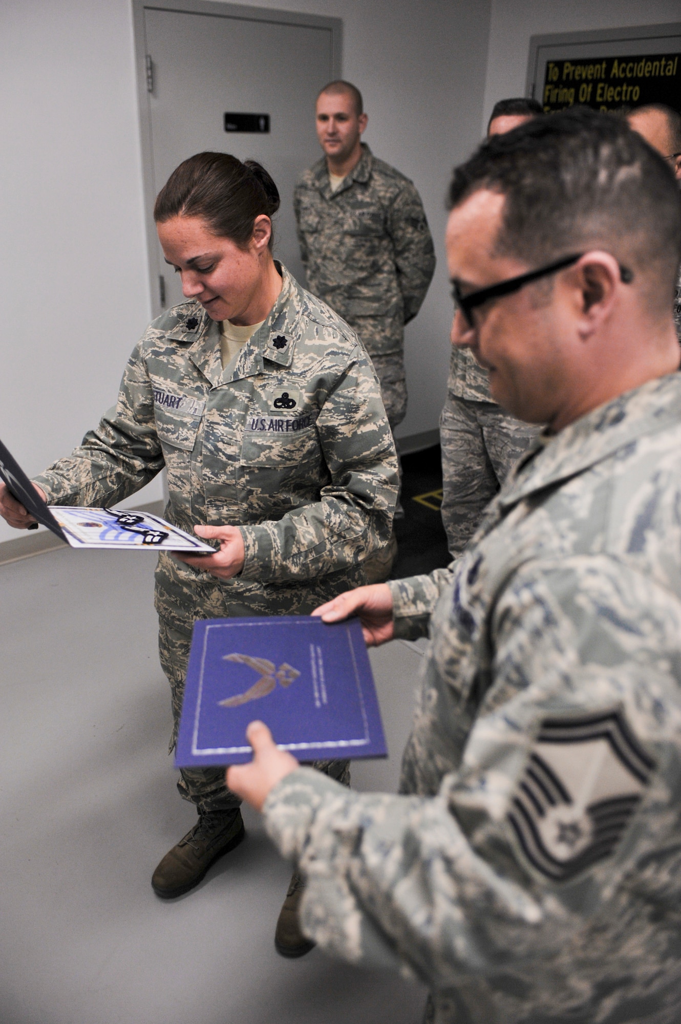 ELMENDORF AIR FORCE BASE, Alaska – Lt. Col. Diana Stuart, 3rd Component Maintenance Squadron commander, gathers with members from her 3rd CMS Egress Flight April 1, as she gets ready to recognize Airmen for promotion. Colonel Stuart recently won the 2009 Air Force Maintenance Effectiveness award for the small aircraft category. (Air Force photo by Airman 1st Class Christopher Gross)