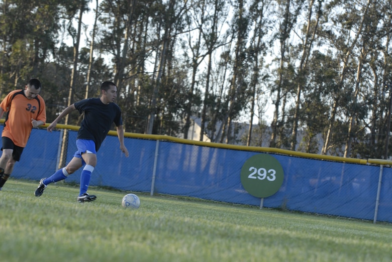 VANDENBERG AIR FORCE BASE, Calif. -- Stephen Higuera, a 14th Air Force soccer team member, chases George Cornejo, a member of the 30th Security Forces Squadron soccer team, during an intramural pre-season soccer game here Thursday, April 1, 2010. The 30th SFS soccer team defeated the 14th AF soccer team 8 - 4. (U.S. Air Force photo/Senior Airman Ashley Reed)


