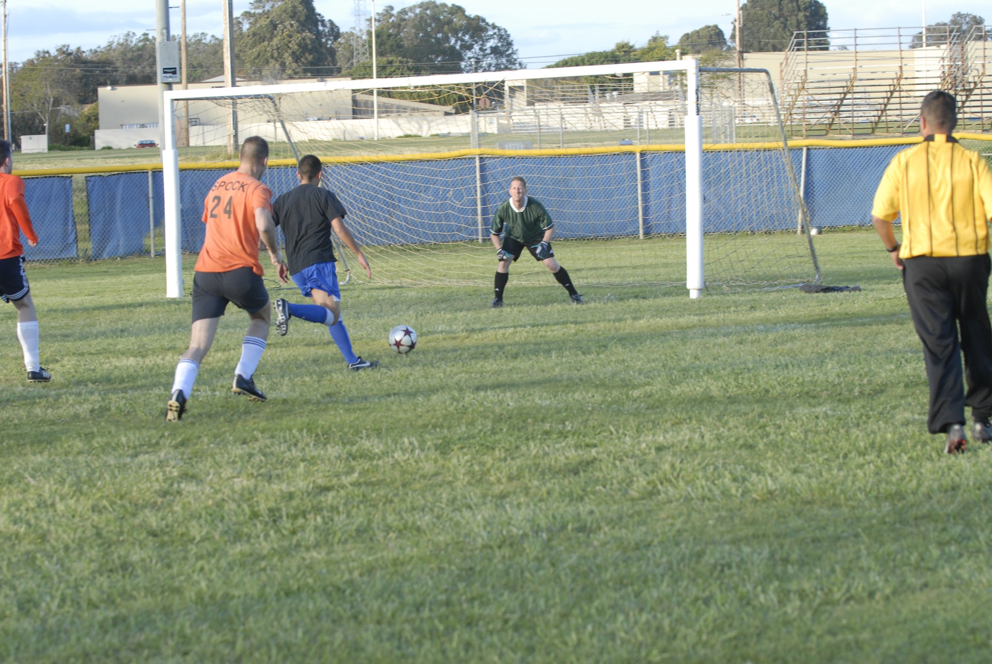 VANDENBERG AIR FORCE BASE, Calif. -- George Cornejo, a 30th Security Forces Squadron soccer team member, takes a shot at the goal as Chris Sullivan, a 14th Air Force soccer team member, prepares to block the shot here Thursday, April 1, 2010. The 30th SFS soccer team defeated the 14th AF soccer team 8 – 4 in an intramural match up. (U.S. Air Force photo/Senior Airman Ashley Reed)
