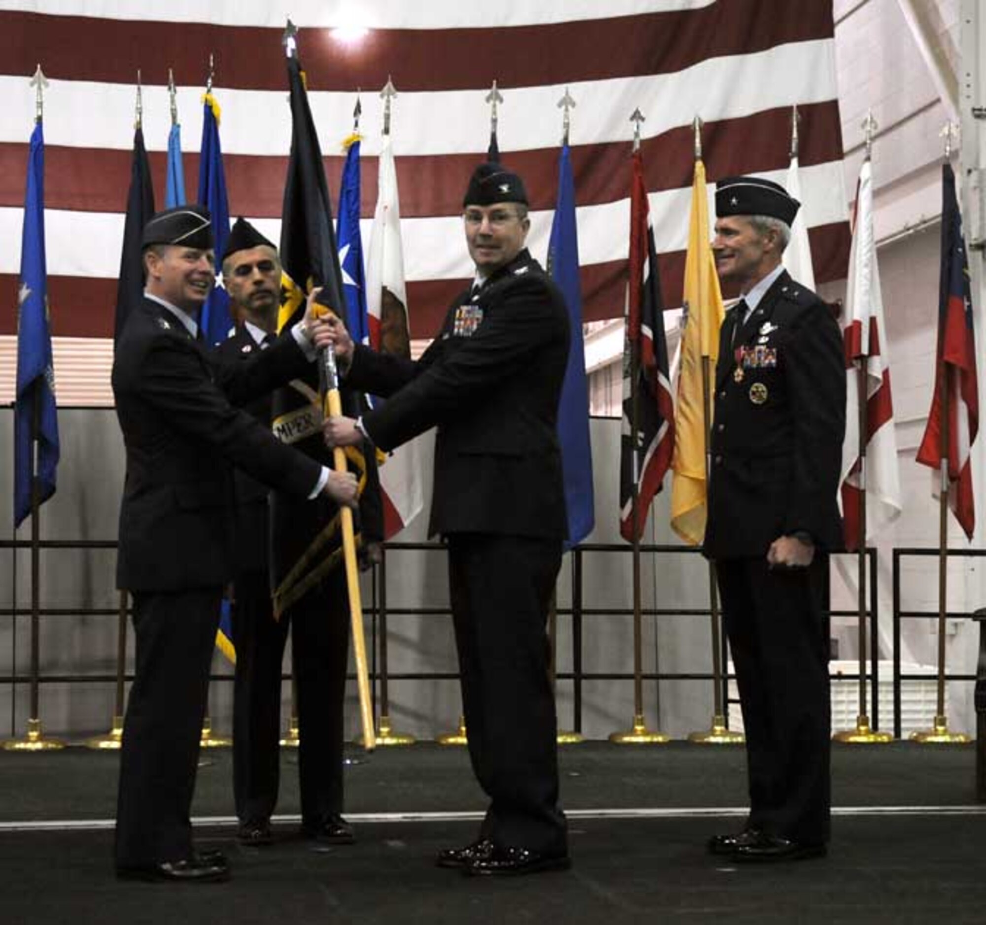 Col. Paul McGillicuddy, incoming 9th Reconnaissance Wing commander, accepts the colors from Lt. Gen. Glenn Spears, 12th Air Force commander, April 2 at Dock 6 during a change of command ceremony. Colonel McGillicuddy comes to Beale from an assignment at the Pentagon. (Air Force photo by Airman 1st Class David Tracy)