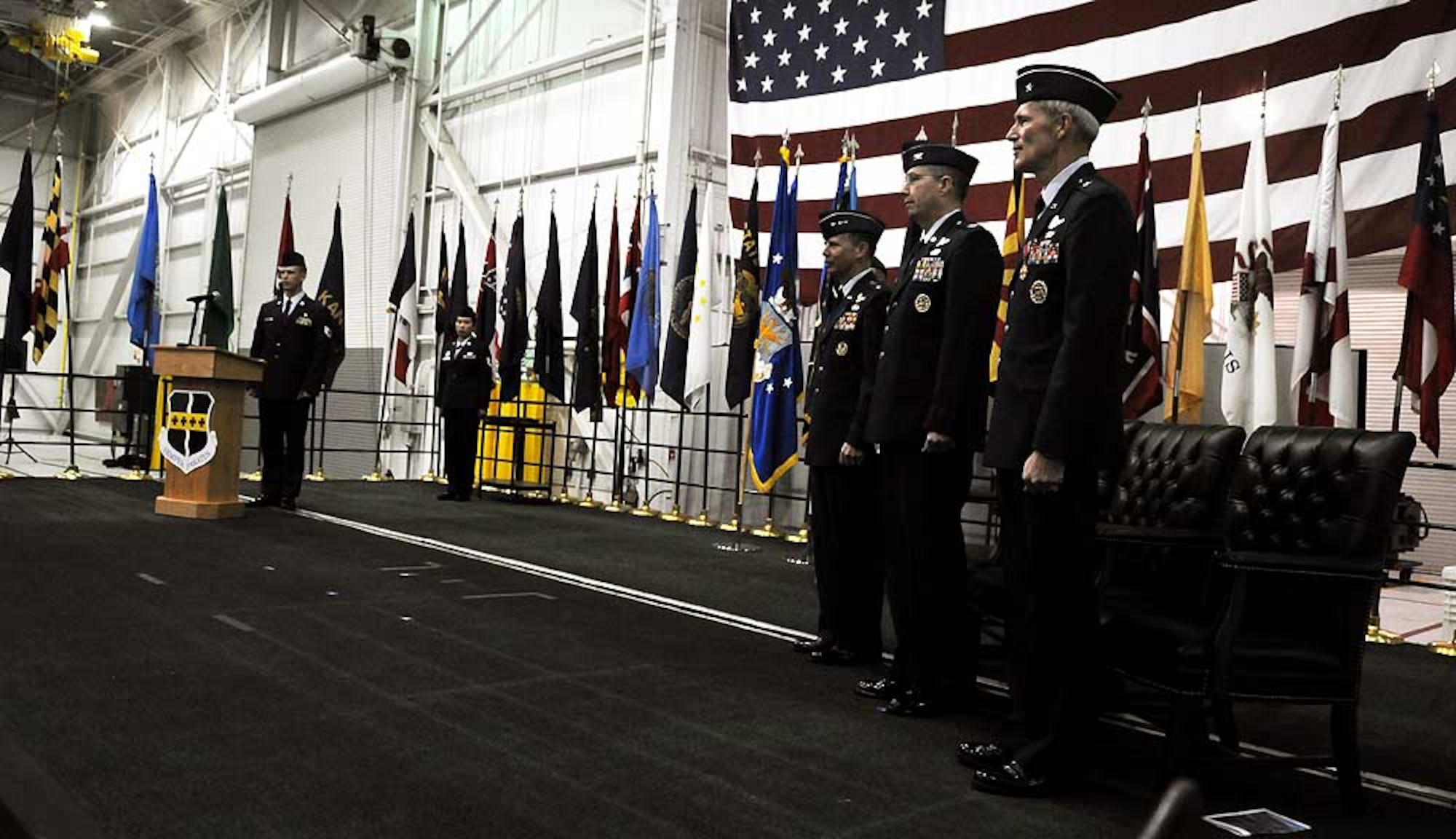 Lt. Gen. Glenn Spears, 12th Air Force commander, Brig. Gen. Robert Otto, outgoing 9th Reconnaissance Wing commander, and Col. Paul McGillicuddy, 9th RW commander, prepare to recite the Air Force song April 2 at Dock 6 during the 9th RW change of command ceremony. Colonel Mcgillicuddy is the 28th commander of the 9th RW. (Air Force photo by Airman 1st Class David Tracy)