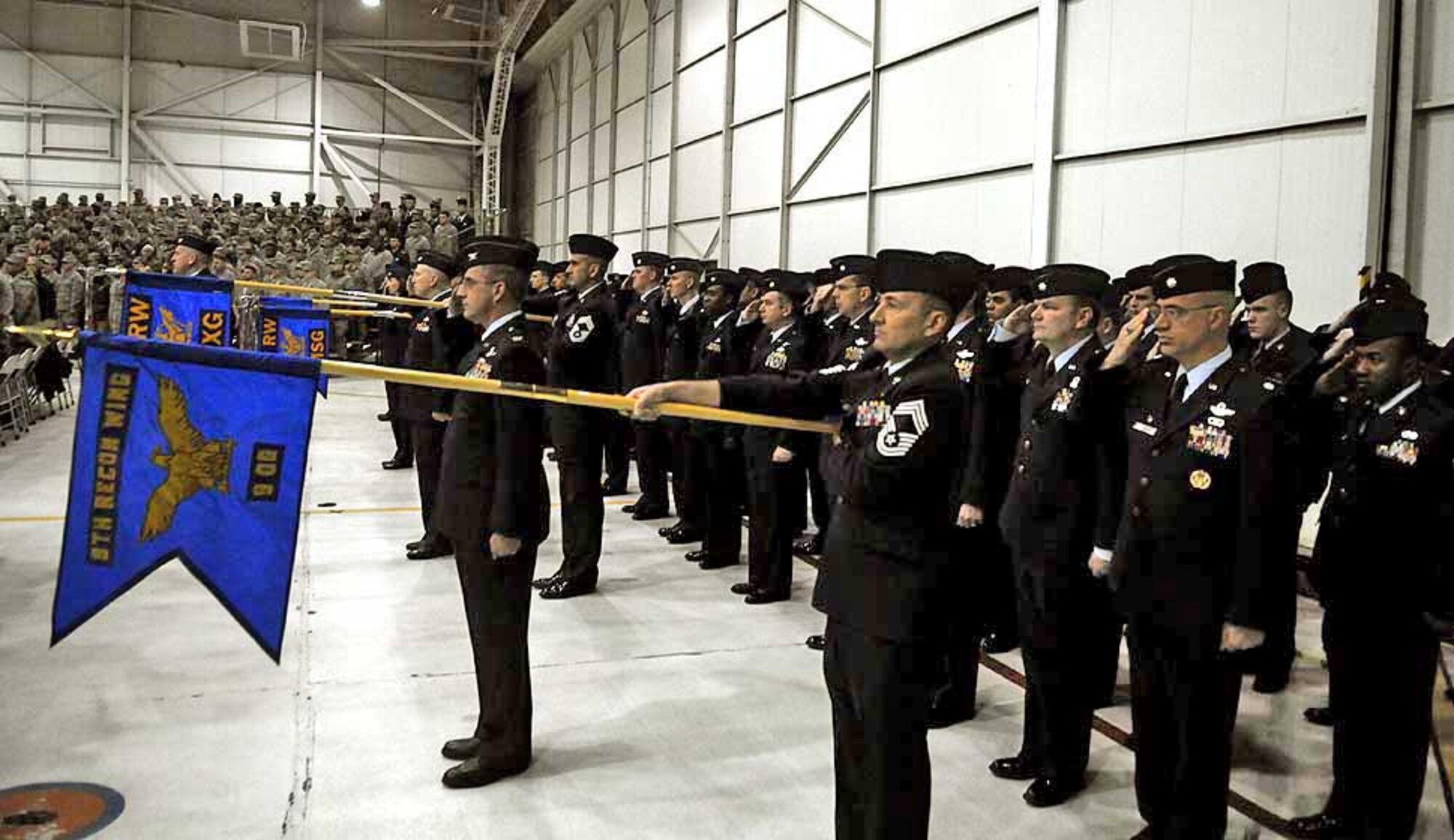 Members of the 9th Reconnaissance Wing give a final salute to Brig. Gen. Robert Otto, outgoing 9th RW commander, April 2 at Dock 6. General Otto relinquished command to Col. Paul McGillicuddy. (Air Force photo by Airman 1st Class David Tracy)