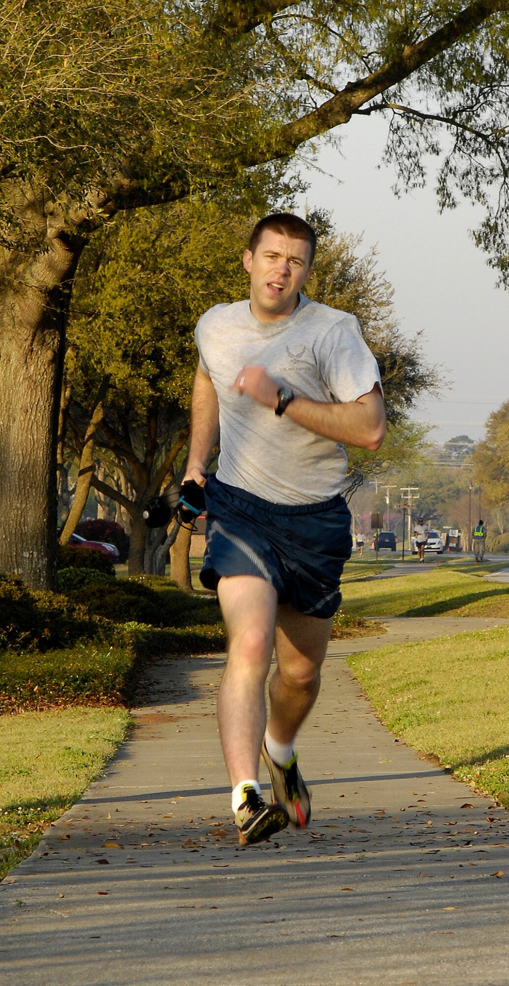 Ryan Peake sprints towards the finish line during the Commander's Fitness Challenge on Joint Base Charleston, S.C., April 2, 2010. Peake finished first for the men with a time of 17 minutes and 34 seconds. Participants in the 5K fitness challenge ran or walked a course along Hill Boulevard, Bates Street, Davis Drive, James Avenue and Jackson Drive. Peake is with the 628th Force Support Squadron. (U.S. Air Force Photo/Airman 1st Class Lauren Main)