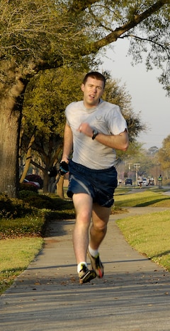 Ryan Peake sprints towards the finish line during the Commander's Fitness Challenge on Joint Base Charleston, S.C., April 2, 2010. Peake finished first for the men with a time of 17 minutes and 34 seconds. Participants in the 5K fitness challenge ran or walked a course along Hill Boulevard, Bates Street, Davis Drive, James Avenue and Jackson Drive. Peake is with the 628th Force Support Squadron. (U.S. Air Force Photo/Airman 1st Class Lauren Main)