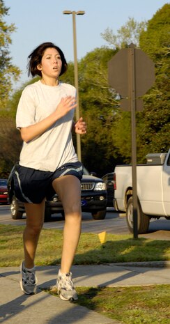 Giovanna Squadrito makes a strong finish during the Commander's Fitness Challenge on Joint Base Charleston, S.C., April 2, 2010. Squadrito finished first for the women with a time of 21 minutes and 59 seconds. The fitness challenge is a monthly tradition on the base and is held the first Friday of each month. (U.S. Air Force Photo/Airman 1st Class Lauren Main)