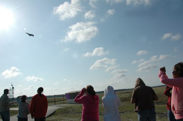 Children from the Taunton Family Children’s Home watch an F-4 Phantom take off. The children learned about the aircraft used as full-scale drones and their mission in the 53rd Weapons Evaluation Group. The group toured Tyndall AFB March 26 during their spring break to see the Air Force in action. (U.S. Air Force photo/ Ashley M. Wright)  