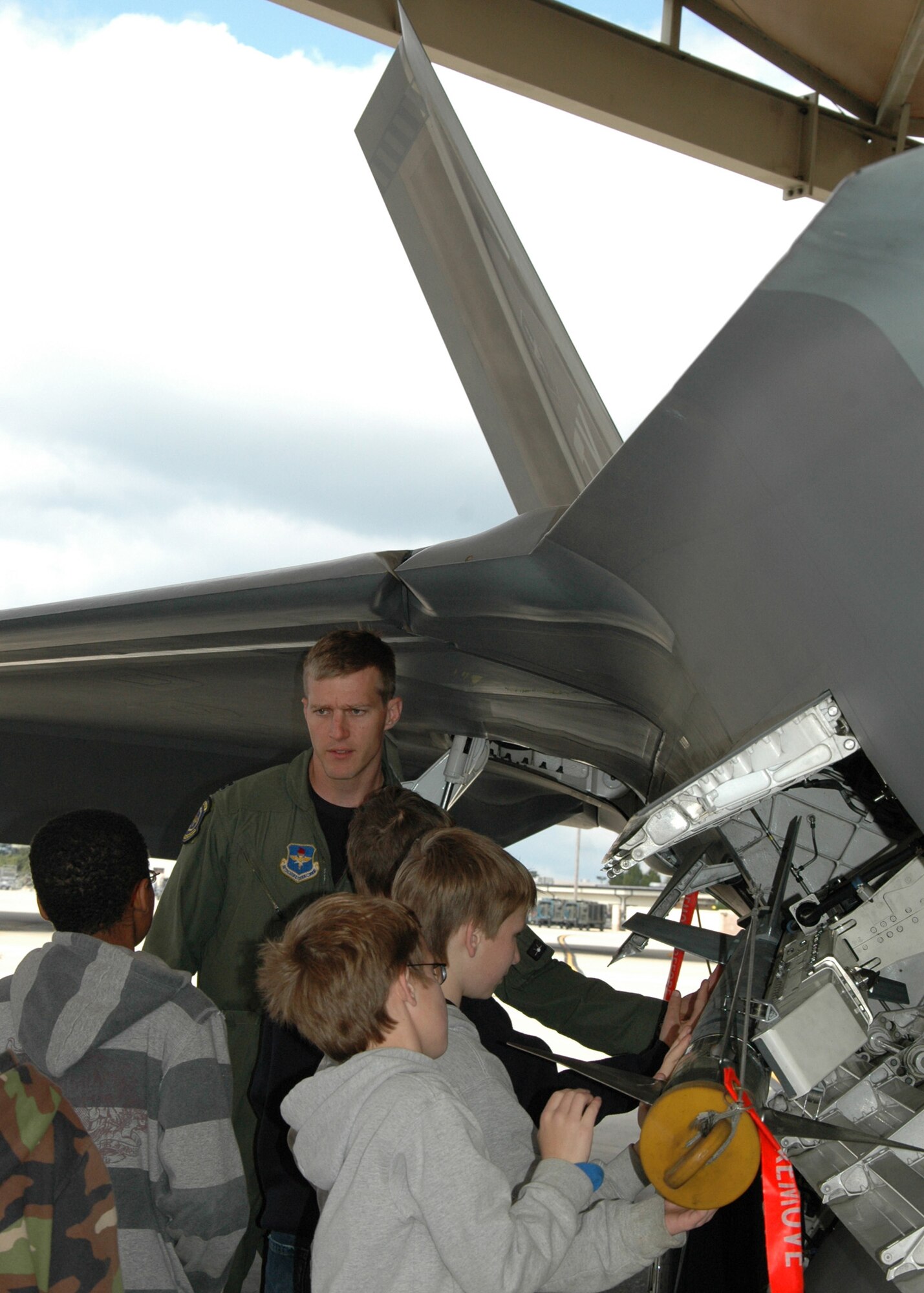 Capt. Scott Bradley, 43rd Fighter Squadron pilot, gives a tour of an F-22 Raptor to children from the Taunton Family Children’s Home. The group toured Tyndall Air Force Base, Fla., March 26 during their spring break to see the Air Force in action. (U.S. Air Force photo/ Ashley M. Wright)  