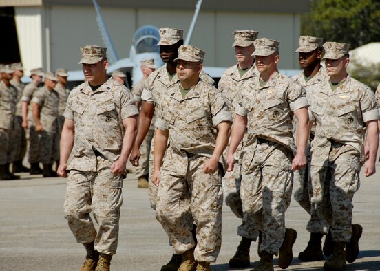 Squadron staff members march during the Marine Fighter Attack Training Squadron 501 stand-up ceremony April 2 at Eglin Air Force Base, Fla. The 501st becomes the first Marine JSF squadron and also the first Marine squadron embedded into a Air Force Wing. Maj. Gen. James F. Flock, 2nd Marine Aircraft Wing commander, called the occasion "the next chapter in the future of Marine aviation." The band came from Cherry Point, N.C. to perform at the ceremony. (U.S. Air Force photo/Samuel King Jr.)