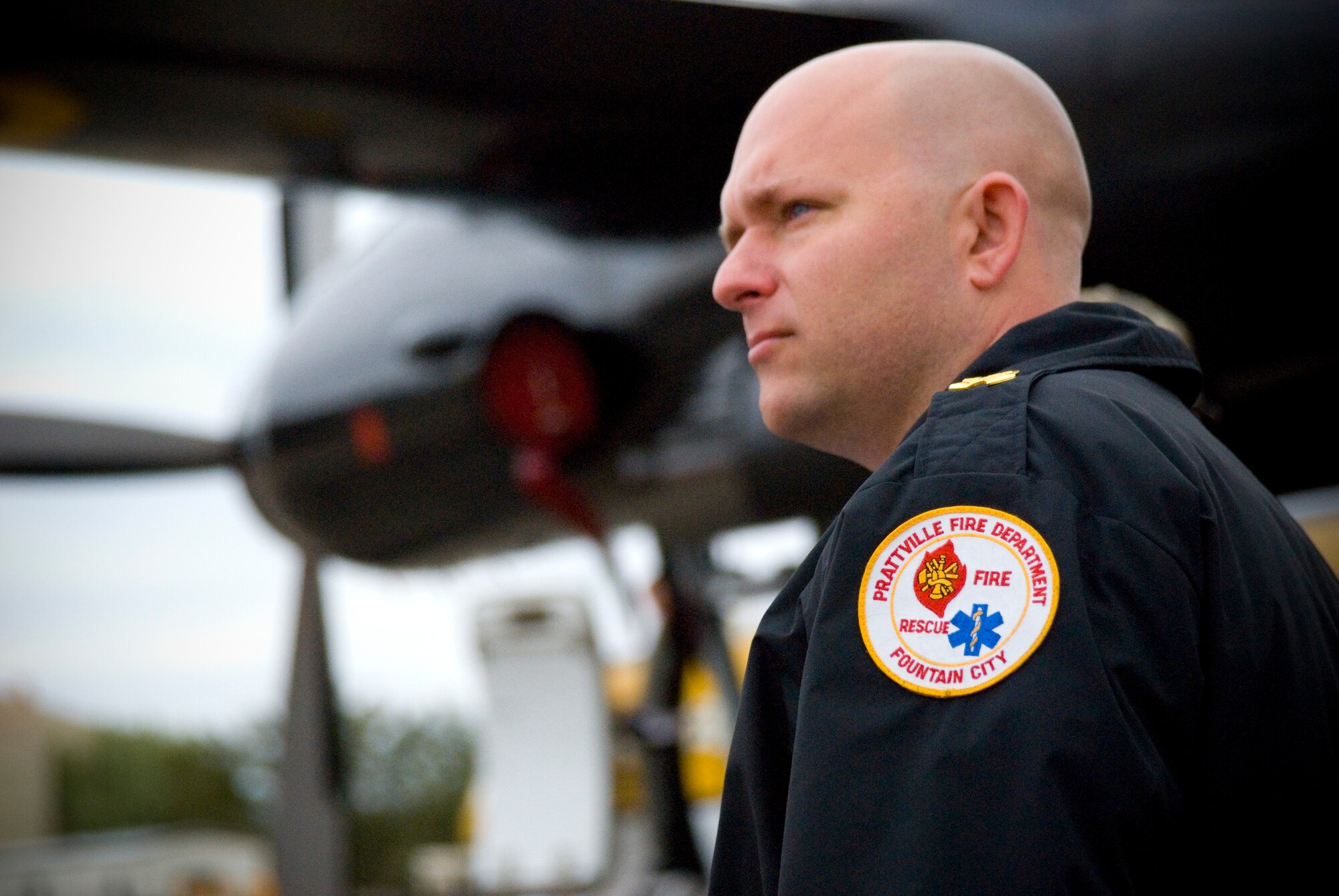 Michael Whaley, battalion commander for the City of Prattville’s fire department, looks on as aircraft practice on the flight line at Maxwell Air Force Base, Ala., after his flight aboard the U.S. Army Golden Knights aircraft. Mr. Whaley was selected as a “Hometown Hero” for his ongoing accomplishments as a leader among his fellow firefighters and his timely and selfless response with his department, following a tornado that destroyed his home in 2008. (U.S. Air Force photo/Scott Knuteson)