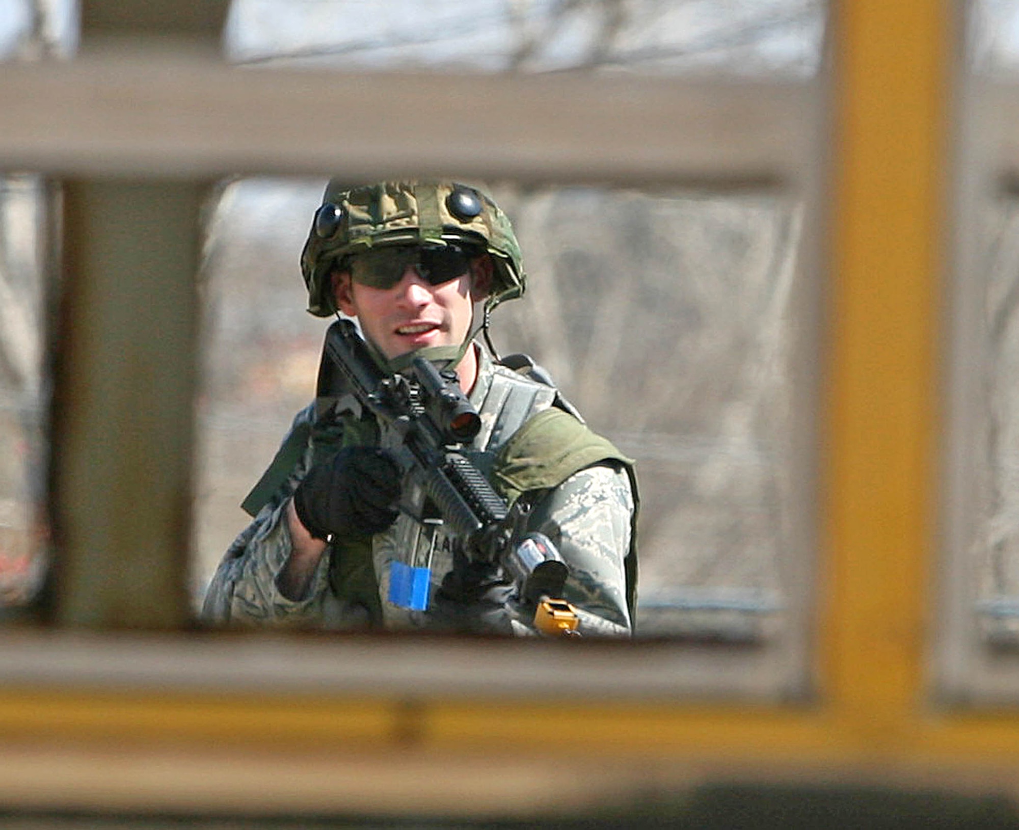 Second Lt. Kenneth Sturgis, with the 3rd Combat Communications Group, peers through the open windows of an old bus at the Glenwood Training Annex March 17. Lieutenant Sturgis is assisting in the training of 16 select 3rd Herd Airmen, who will compete in the upcoming Guardian Challenge at Tinker April 16-19. (Air Force photo by John Stuart)
