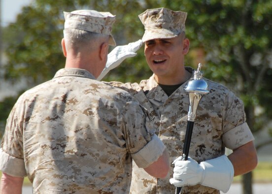 Gunnery Sgt. Victor Miranda, 2d Marine Aircraft Wing Band drum major, salutes Gen. James Amos, assistant commandant of the Marine Corps, prior to the Marine Fighter Attack Training Squadron 501 stand-up ceremony April 2 at Eglin Air Force Base, Fla. The 501st becomes the first Marine JSF squadron and also the first Marine squadron embedded into a Air Force Wing. Maj. Gen. James F. Flock, 2nd Marine Aircraft Wing commander, called the occasion "the next chapter in the future of Marine aviation."  The band came from Cherry Point, N.C. to perform at the ceremony.  (U.S. Air Force photo/Samuel King Jr.)