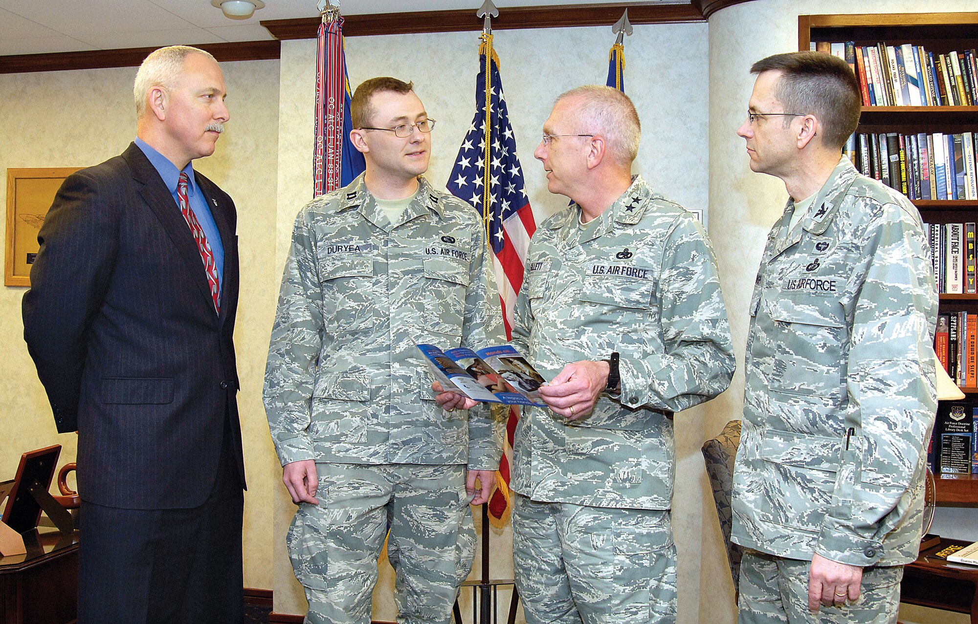 Leaders from the Oklahoma City Air Logistics Center discuss the Air Force Assistance campaign funds with this year’s campaign organizer, Capt. John Duryea, 38th Cyberspace Engineering Group. From left: John Over, OC-ALC executive director; Captain Duryea; Maj. Gen. David Gillett, OC-ALC commander; and Col. Paul Waugh, OC-ALC vice commander. (Air Force photo by Margo Wright)
