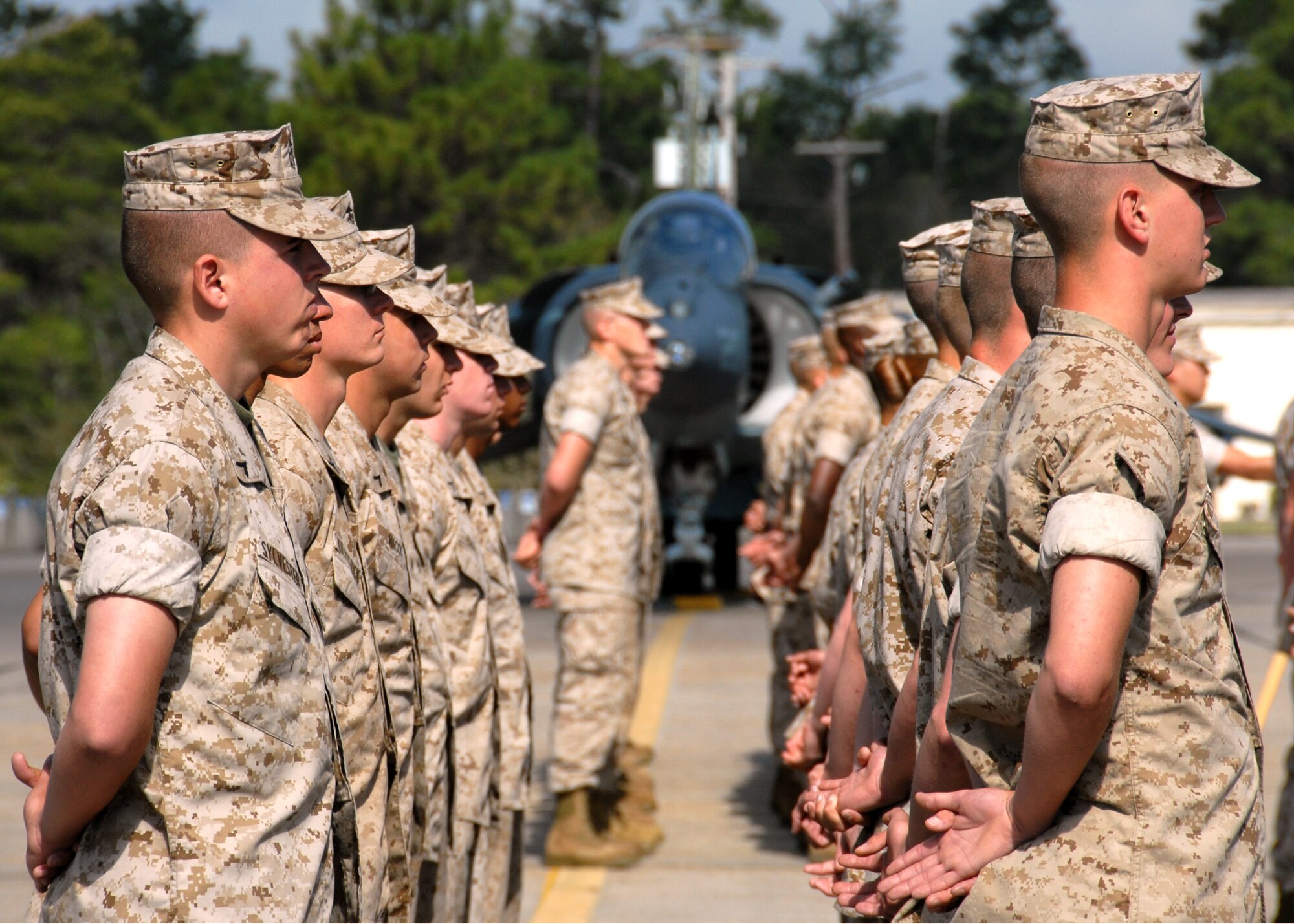 A formation of Marines stand at parade-rest prior to the Marine Fighter Attack Training Squadron 501 stand-up ceremony April 2 at Eglin Air Force Base, Fla. The 501st becomes the first Marine JSF squadron and also the first Marine squadron embedded into a Air Force Wing. Maj. Gen. James F. Flock, 2nd Marine Aircraft Wing commander, called the occasion "the next chapter in the future of Marine aviation." (U.S. Air Force photo/Samuel King Jr.)