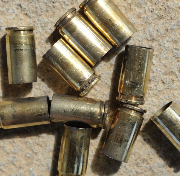 MOODY AIR FORCE BASE, Ga. -- The brass cartridges start to build up as Airmen qualify on the Beretta M-9 handgun at the Combat Arms Training and Maintenance range here March 3. Once construction is completed for a partially-contained firing range, property behind the range will be available for other uses. (U.S. Air Force photo by Airman 1st Class Benjamin Wiseman/RELEASED)