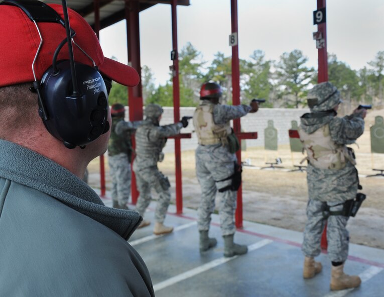 MOODY AIR FORCE BASE, Ga. -- Staff Sgt. Jonathan Grimes, 23rd Security Forces Squadron combat arms instructor, watches over the firing line as Moody Airmen fire the Beretta M-9 handgun here March 3. The Combat Arms Training and Maintenance range will be under construction for six to eight months while a new fully-contained firing range for the 820th Security Forces Group is being built. (U.S. Air Force photo by Airman 1st Class Benjamin Wiseman/RELEASED)