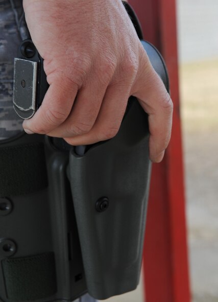 MOODY AIR FORCE BASE, Ga. -- A Moody Airman prepares to fire the Beretta M-9 handgun during weapon qualifications here March 3. The staff members of the Combat Arms Training and Maintenance range qualify about 3,500 military members a year. (U.S. Air Force photo by Airman 1st Class Benjamin Wiseman/RELEASED) 