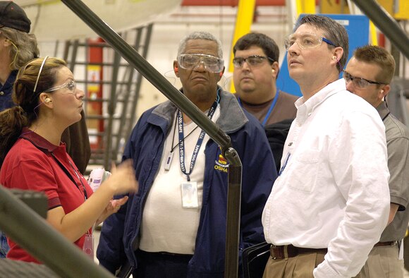 Karol Glessner, 72nd Air Base Wing Safety Office, answers questions about safety practices for aircraft maintenance personnel working on a KC-135 in a Bldg. 3001 dock during a March 26 tour by Occupational Safety and Health Administration officials.  

Dr. Landis Powell, OSHA Voluntary Protection Program coordinator, center, and David Bates, OSHA area director, in white, learned about Tinker’s VPP successes and visited with personnel. Behind them are Ty Norton, AFGE Local 916, VPP, left, and visitor Johnny Vanbuskirk, one of three Valero Refinery VPP mentors. 

Tinker won the Air Force top award for ground safety in 2010. On the job injuries are down 30 percent since VPP implementation in 2006. (Air Force photo by Margo Wright)
