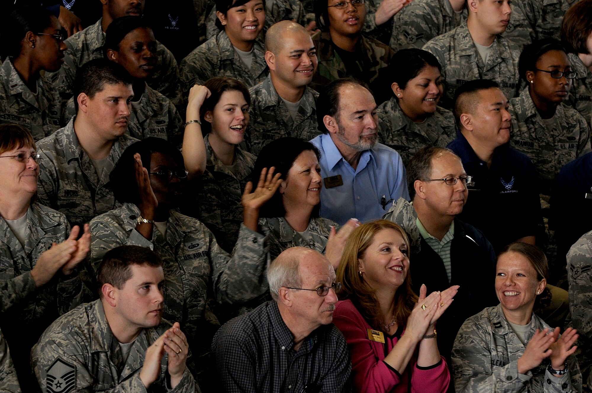 Airmen from the 375th Air Mobility Wing cheer during the rating announcement on its Operational Readiness Inspection at Hangar 1, April 2, 2010. The 375th AMW received an overall excellent rating and several teams and individuals were recognized for their superior performance. (U.S. Air Force photo by Staff Sgt. Brian J. Ellis) 