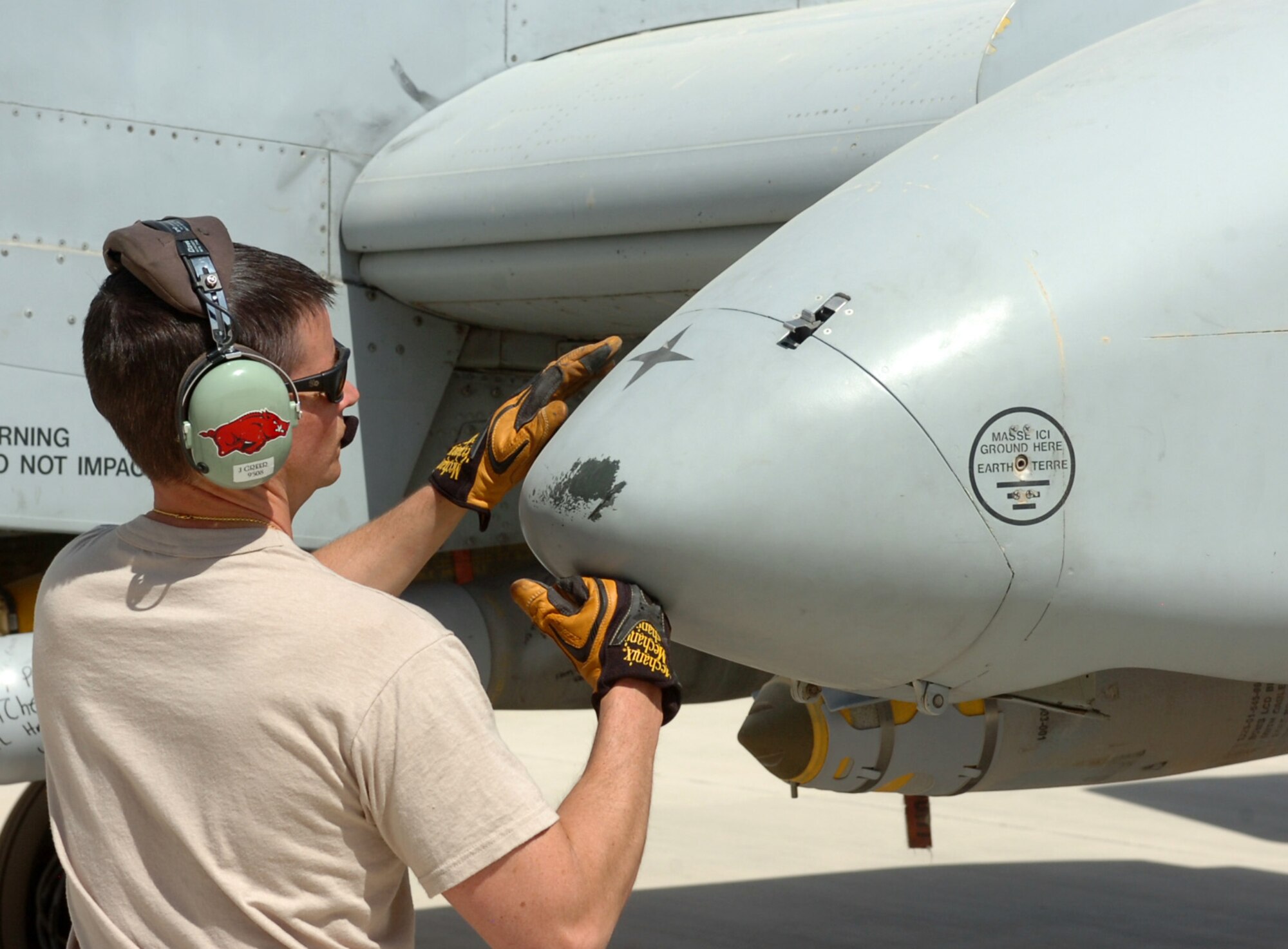 Master Sgt. Jay Greer, an aircraft crew chief from the 188th Fighter Wing, Arkansas Air National Guard, based in Fort Smith, buttons up a wing pod on his A-10C Thunderbolt II aircraft before takeoff. Greer and more than 250 members of the 188th are deployed to Kandahar Airfield, Afghanistan as part of an Air Expeditionary Force rotation through May. (Photo by Lt. Col. Keith Moore/Arkansas Air National Guard Public Affairs).