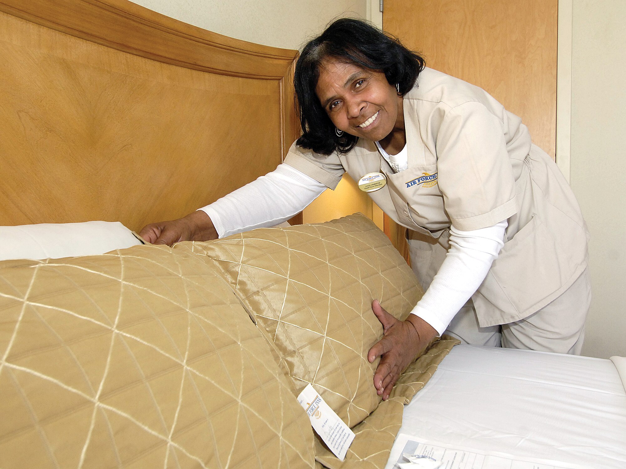 For six years, Linda Hammon has been treating Tinker high ranking visitors like family.  The guest room attendant at the Indian Hills Inn Lodging cares for 10 suites used by civilian leaders, generals and special base guests. “I meet them as family and try to make their lives enjoyable, make their rooms like home,” she says with a smile. She volunteered to care for the suites after being here for two years, though she stills attends to other areas in the inn when she can. “I enjoy everyone who comes through. I want to make them more comfortable and will point out where to eat or how to get to the commissary and base exchange,” she said.  Many returning leaders remember her and bring gifts to her and the lodging staff.  Perry Hicks, Ms. Hammon’s supervisor, praises her attention to detail and the work she does for the visitors. “It’s not just what you do,” he told her, “But they like you as an individual.” (Air Force photo by Margo Wright)