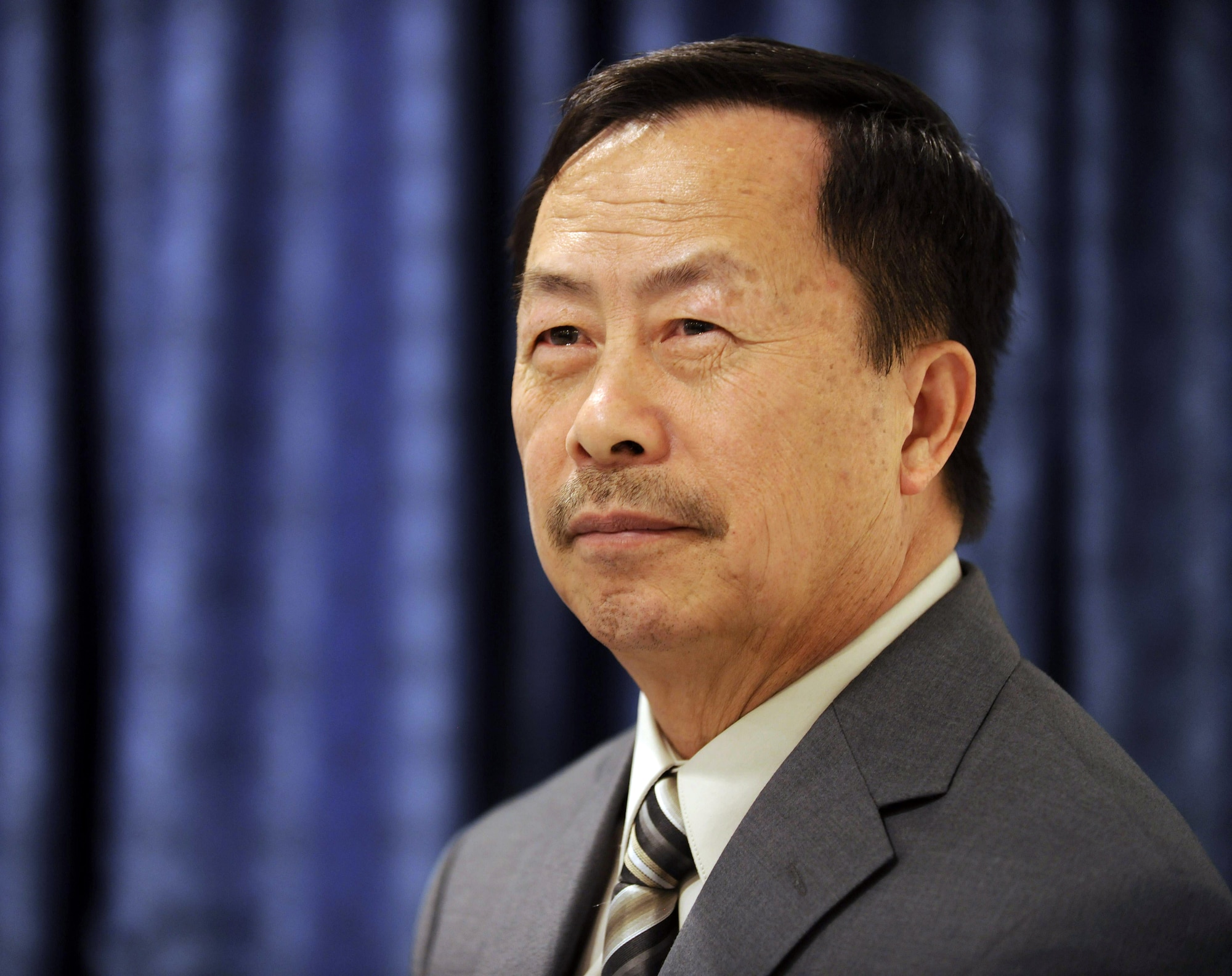 Yia Kha listens as Air Force Chief of Staff Gen. Norton Schwartz says a few words during a ceremony March 31, 2010, in the Pentagon's Airmen's Hall. Mr. Kha received a certificate of appreciation from General Schwartz for his role in aiding forward air controllers during the Vietnam War. (U.S. Air Force photo/Scott Ash)