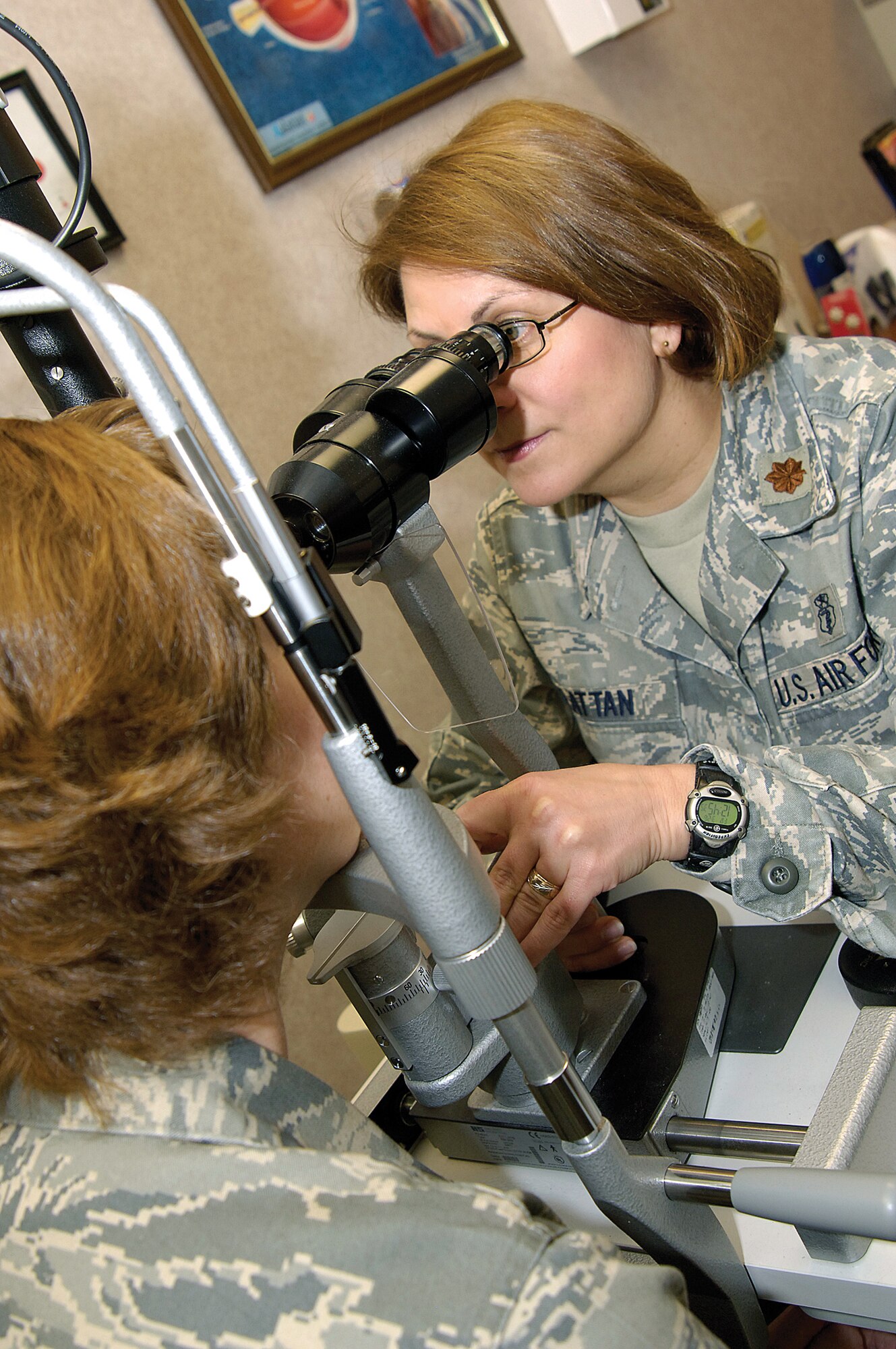 Approximately 600 patients a month come to the Optometry Clinic of the 72nd Aerospace Medicine Squadron. Maj. Judy Rattan uses a slit lamp to look at the structures of an eye. (Air Force photo by Margo Wright)