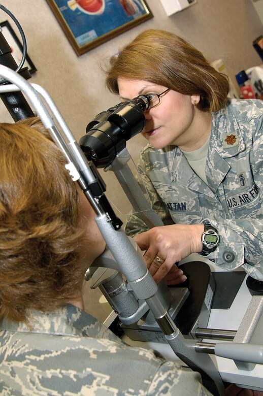 Approximately 600 patients a month come to the Optometry Clinic of the 72nd Aerospace Medicine Squadron. Maj. Judy Rattan uses a slit lamp to look at the structures of an eye. (Air Force photo by Margo Wright)