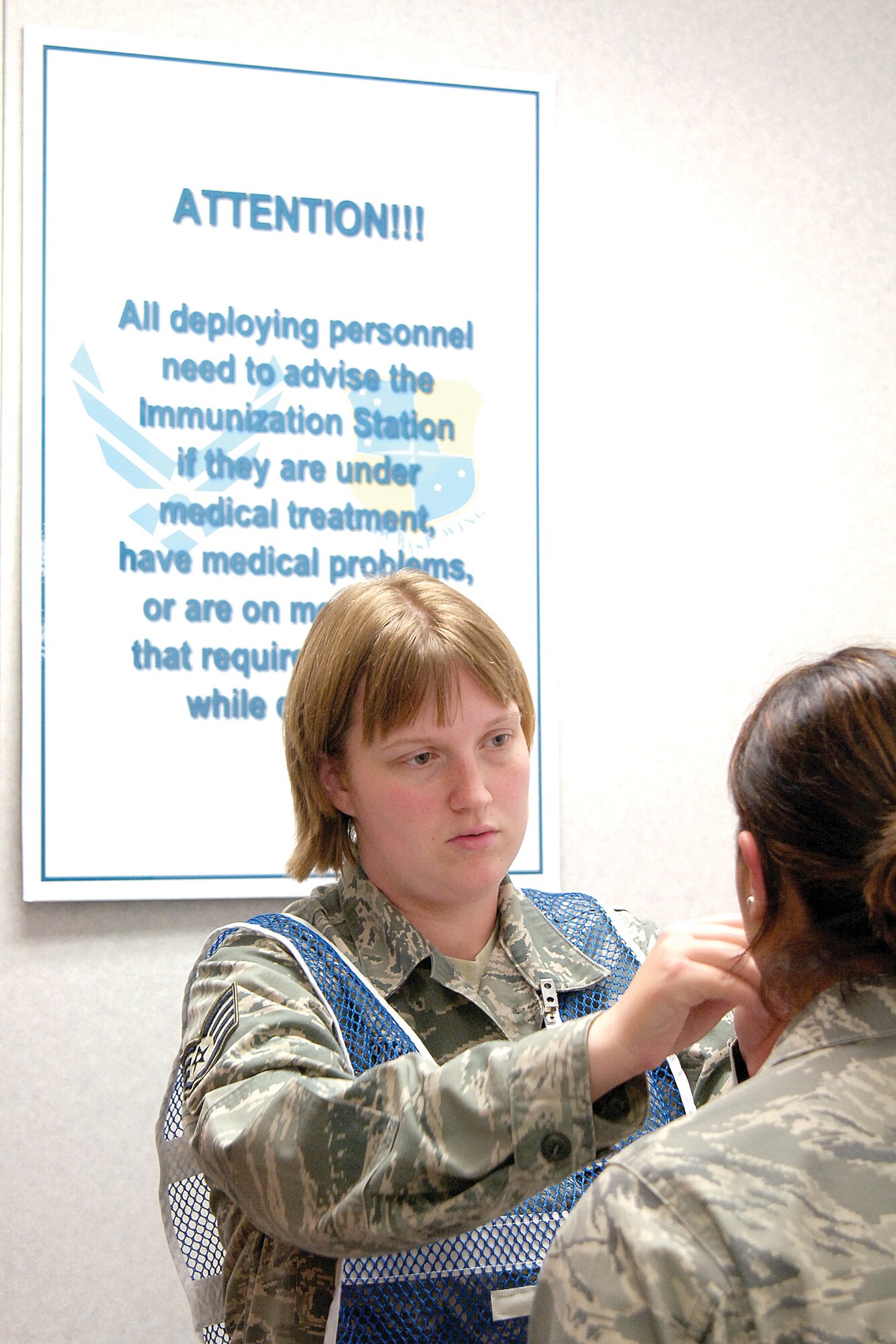 During deployment readiness exercises, Immunizations personnel take their vaccines to the mobility processing line.  Staff Sgt. Tiffany Gordon administers a nasal flu mist to a deploying Airman. (Air Force photo by Margo Wright)
