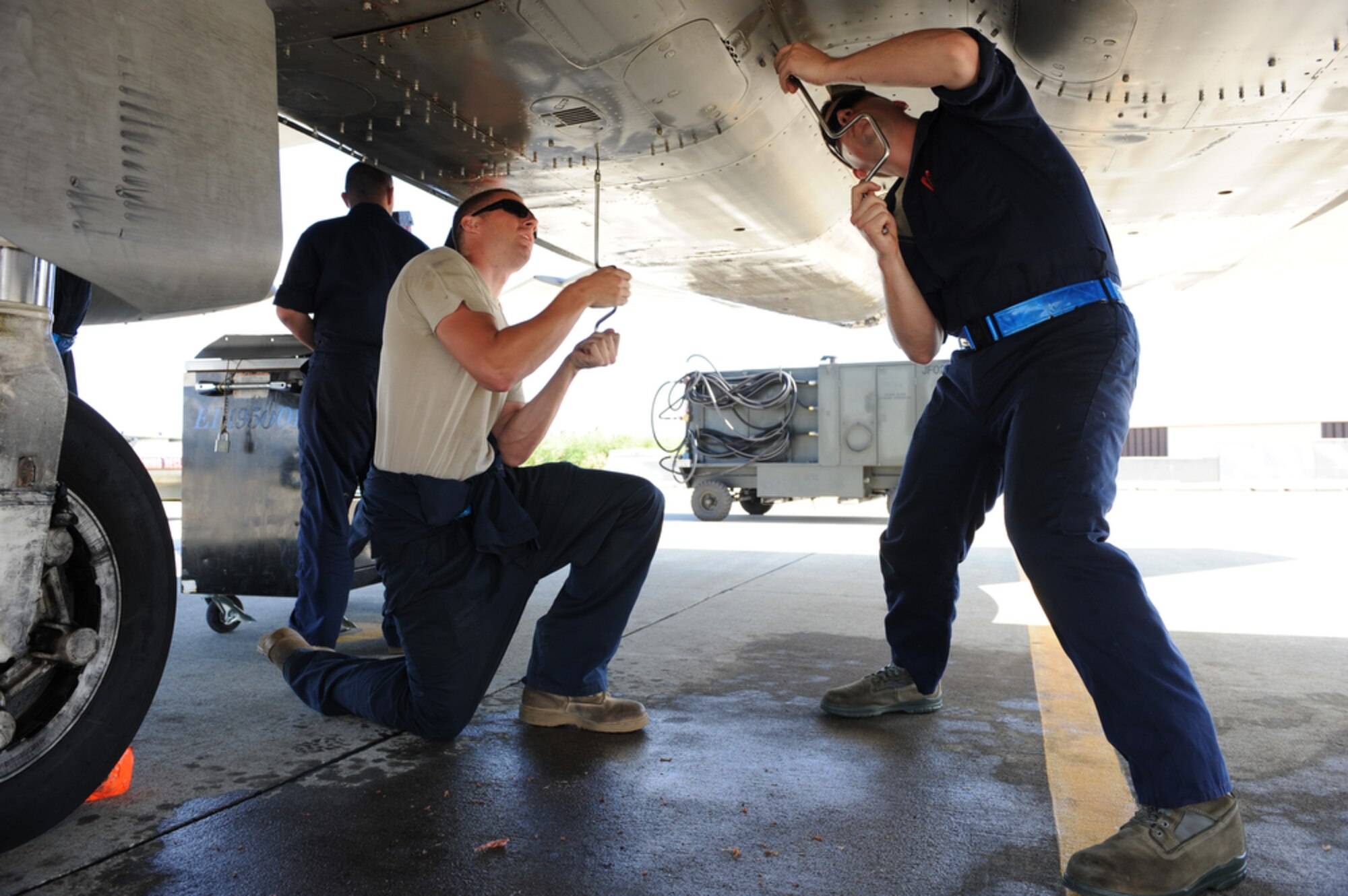 JOINT BASE PEARL HARBOR-HICKAM, Hawaii - F-15 Eagle crew chiefs Senior Airman Aaron Kippels and Tech. Sgt. Daniel Misiak remove panels from an F-15 during a maintenance check while deployed to Joint Base Pearl Harbor-Hickam, Hawaii March 23.  Both are assigned to the 19th Aircraft Maintenance Unit, 3rd Maintenance Squadron, Elmendorf Air Force Base, Alaska. (Air Force photo by Tech. Sgt. Cohen A. Young)