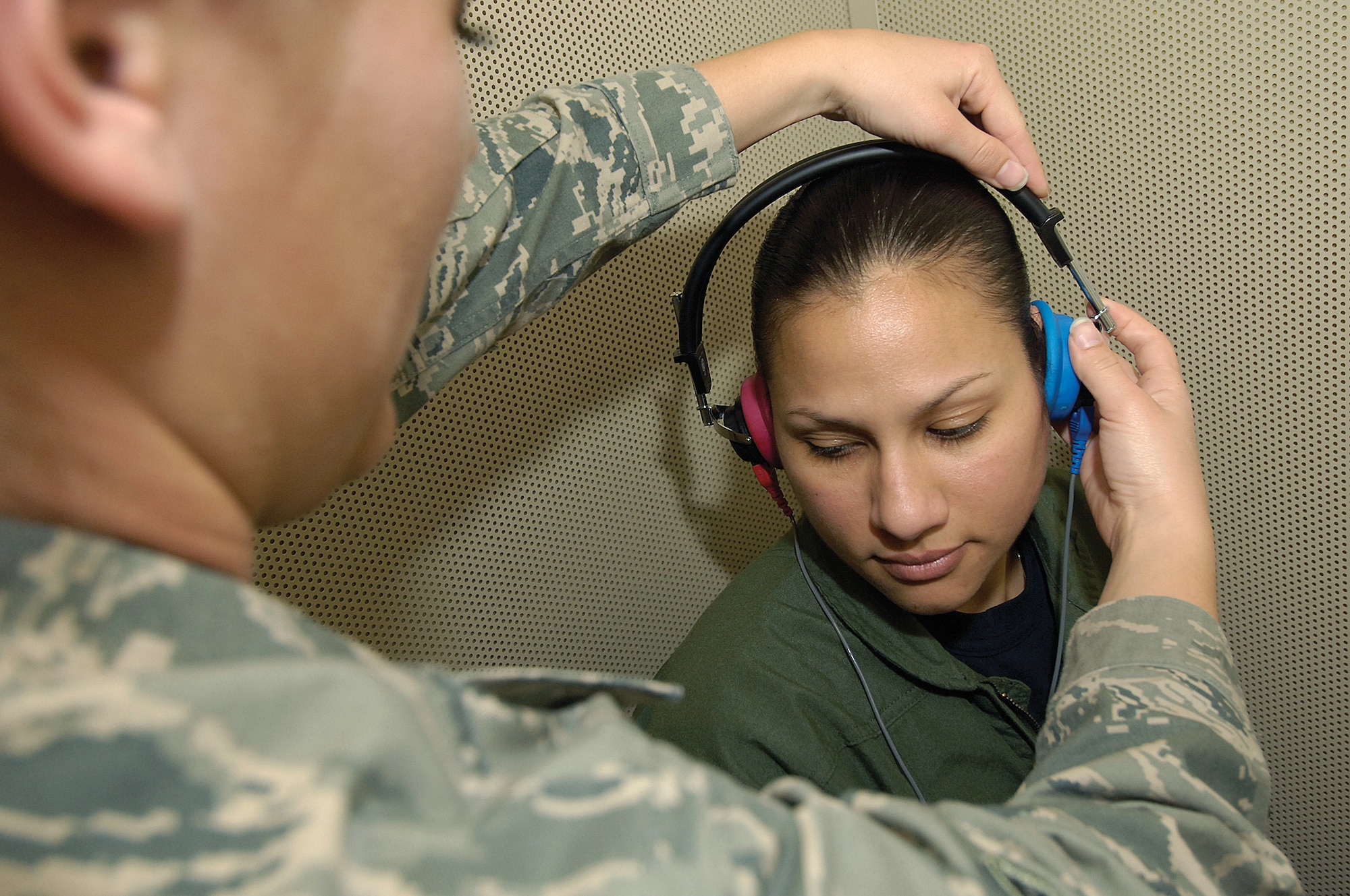 Airman 1st Class Angia Camp adjusts earphones before a hearing test in an audiology testing booth of the Public Health Flight. The flight handles everything “from AIDS to zucchini” says commander Maj. Juan Ramirez, of their responsibilities. The fight acts similarly to a state health department and works jointly with off base agencies in tracking and reporting health information. They have been a focal point for base H1N1 vaccinations, check food safety in all base establishments, monitor mosquito populations here and even do a “tick drag” at the Glenwood Training Area to tell where to spray before exercises. (Air Force photo by Margo Wright)