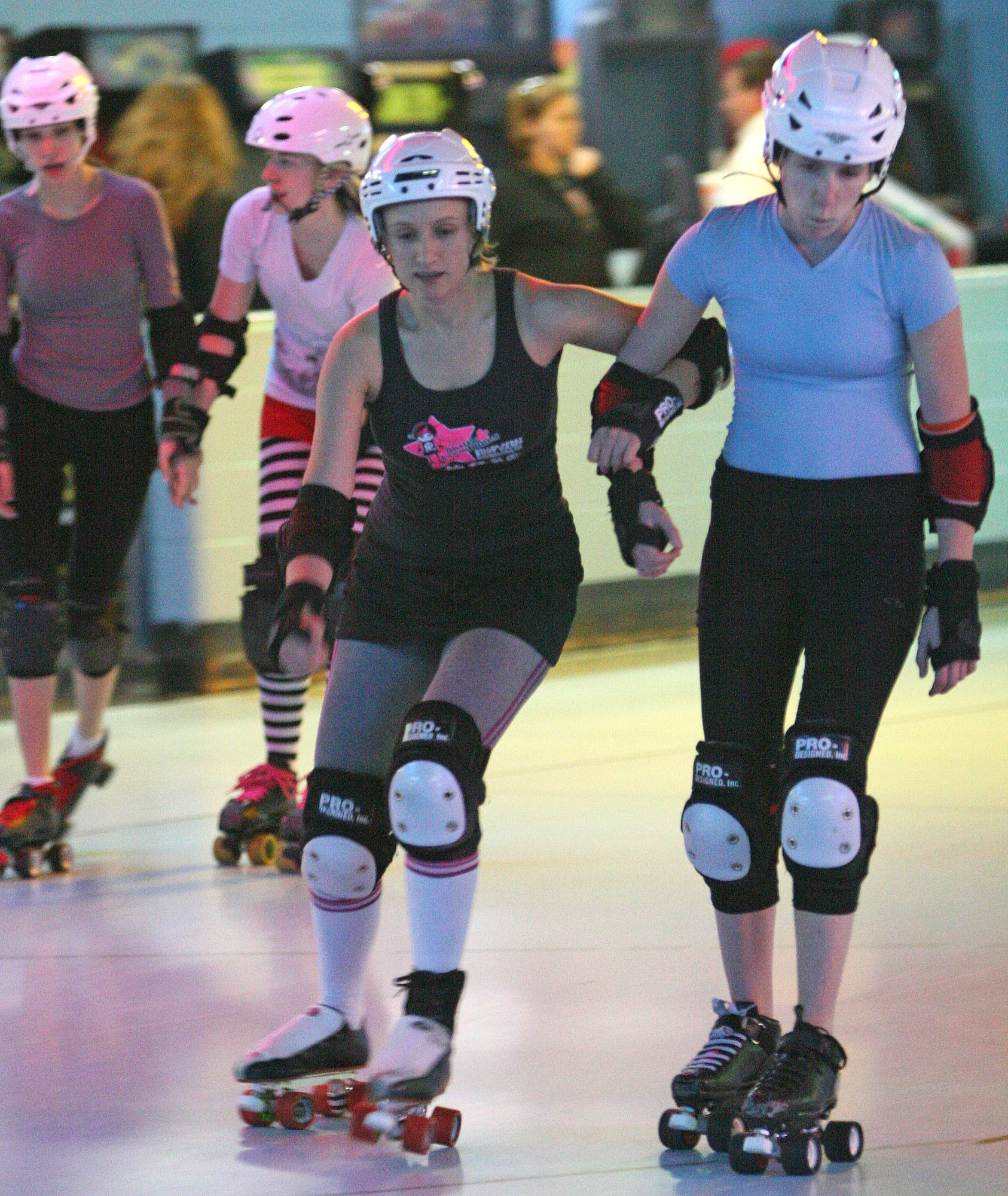 Nicole Messinger, left, blocks out a teammate during a Victory Dolls practice. Messinger joined the team in 2008 and took the leap into the world of roller derby. (Air Force photo by John Stuart)