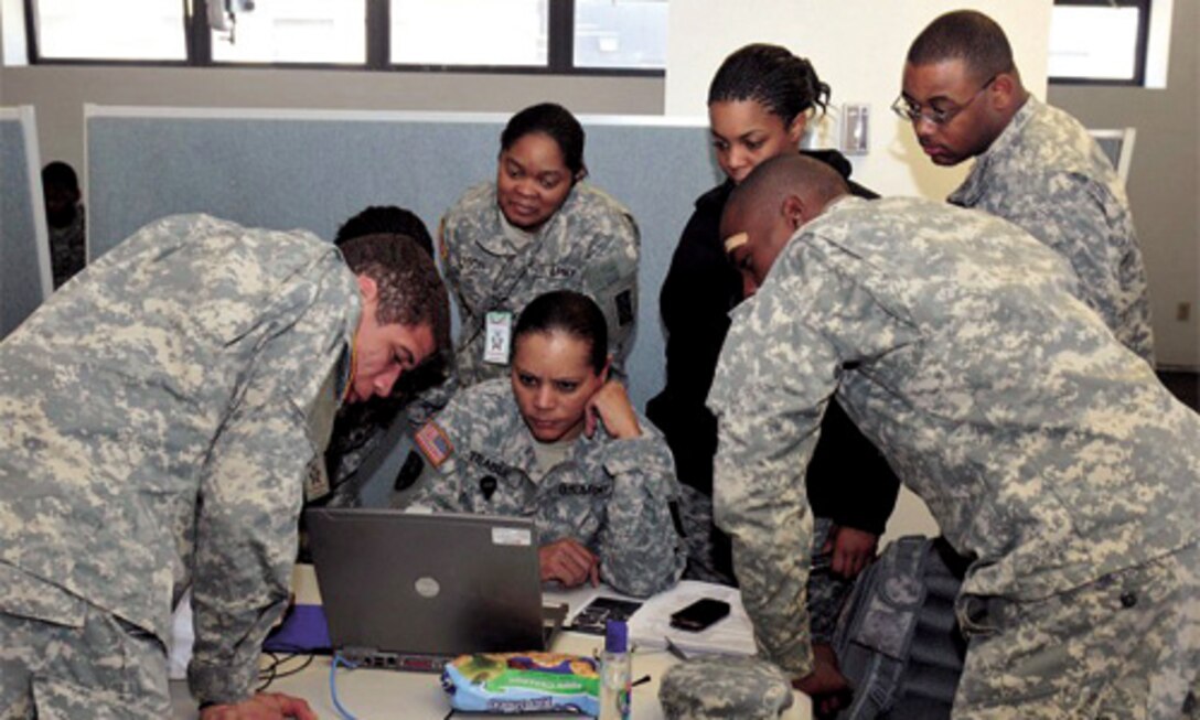 FORT EUSTIS, Va. -- A group of Casualty Liaison Team Soldiers surround Sgt. 1st Class Emma TraBue, 3rd Adjutant General Personnel Center, 143rd Sustainment Command (Expeditionary), to assist her with a casualty report during Silver Scimitar Saturday at Fort Devens, Mass.
(Photo by R.J. Gilbert)