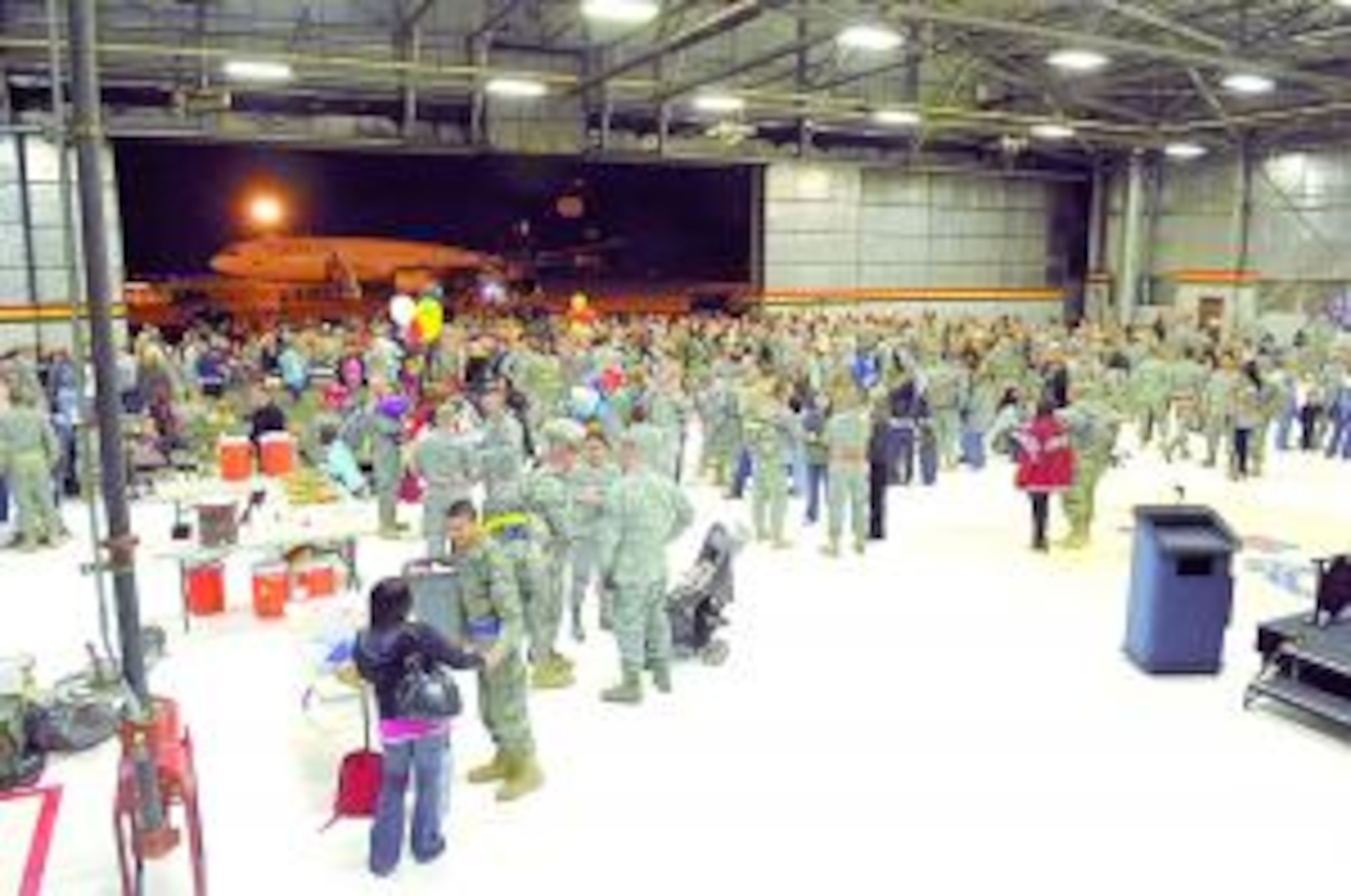 Members of the 729th Air Control Squadron returning from a deployment to Iraq meet family and friends in Hangar 37 on March 24. A band, Hush House, was there to help in the greeting of the approximately 170 returning members. (Air Force photo by Todd Cromar)