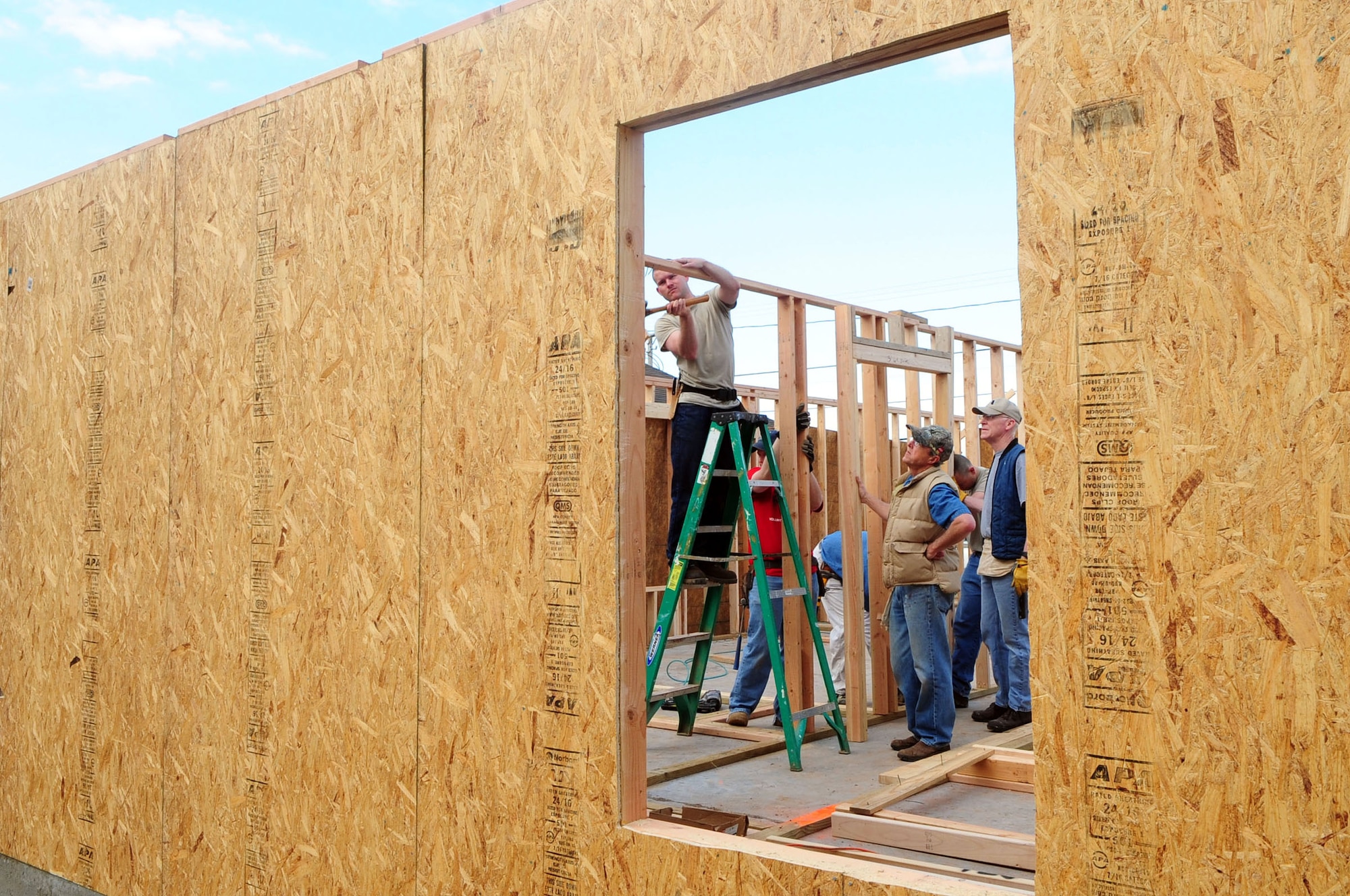 Members of Barksdale Air Force Base, La., 2nd Civil Engineer Squadron and the local community secure an interior wall on the first day of construction of a Habitat for Humanity home March 20, 2010, in Shreveport, La. The home is being constructed for the Hart family, formerly from New Orleans who came to Shreveport after Hurricane Katrina. (U.S. Air Force photo/Senior Airman Joanna M. Kresge)