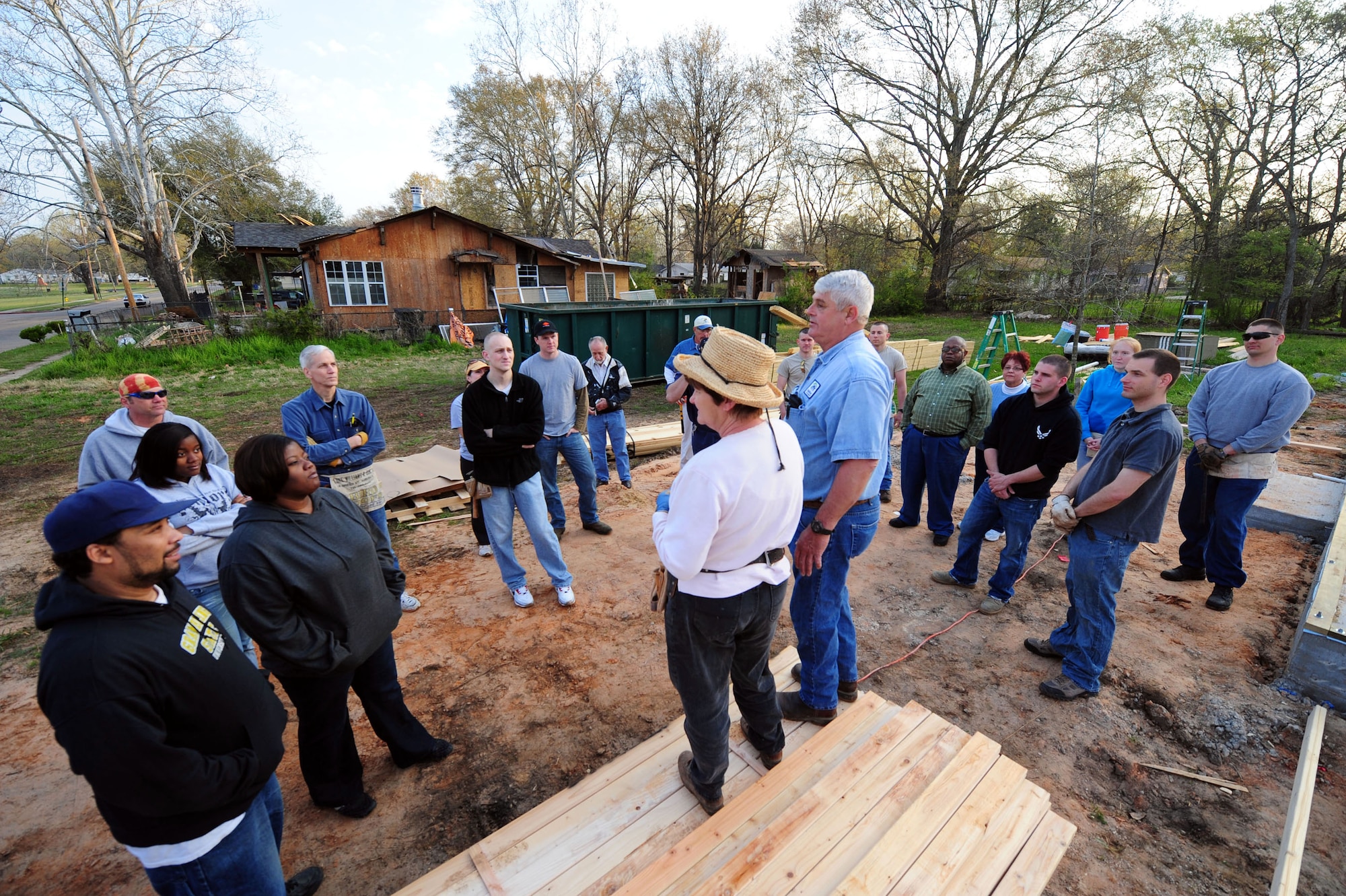 Members of the local community and Airmen from Barksdale Air Force Base, La., receive a safety briefing from Habitat for Humanity volunteers before beginning construction of a new home March 20, 2010, in Shreveport, La. More than 20 Barksdale AFB Airmen from the 2nd Civil Engineer Squadron volunteered to help with the construction. (U.S. Air Force photo/Senior Airman Joanna M. Kresge)
