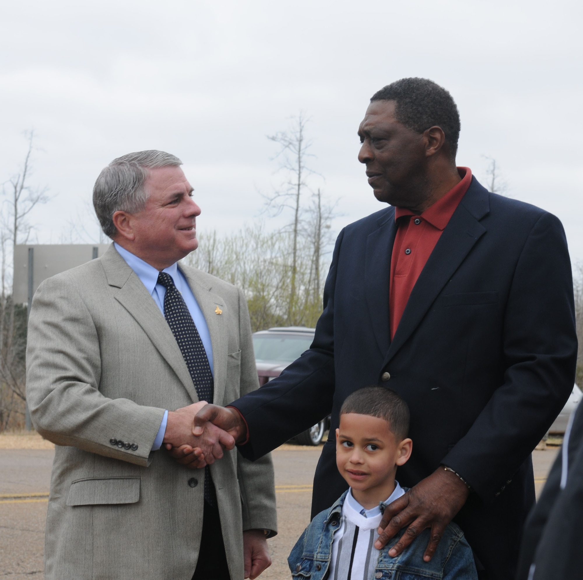 Mississippi Department of Transportation Northern District Highway Commissioner, Mr. Bill Minor, shakes the hand of George Irby, son of  George "Happy" Irby, at the dedication of the road to the Columbus AFB main entrance as the George "Happy" Irby Parkway March 26. (U.S. Air Force photo/Melissa Duncan). 
