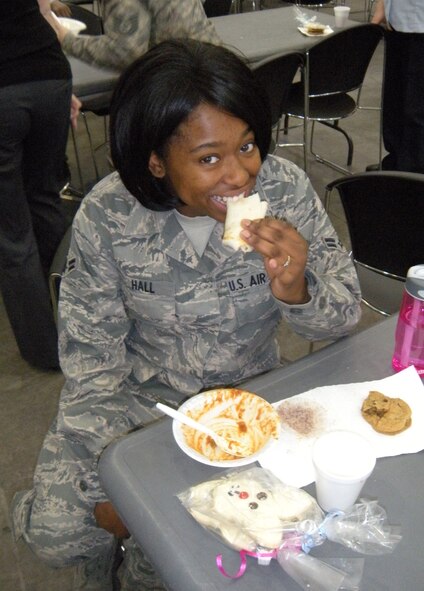 Airman 1st Class Angela Hall, a personnelist assigned to the 39th Aerial Port Squadron, chows down on a tortilla with her chili April 1 during the annual 302nd Airlift Wing chili cookoff event at Peterson Air Force Base, Colo. "I liked number 18 out of the chili choices," she explained. "It was a little spicy and had a bit more flavor." Located in the 39th APS building, 18 competitors submitted their green or red chili creations for either a first, second or third award recognition of "best chili" in their category. For the green chili category: 1st, Master Sgt. David Robbin; 2nd, Senior Master Sgt. Dean Firestein; and 3rd, Mrs. Katie Davidson. For the red chili category: 1st, Master Sgt. Pam Scharfenberg; 2nd, Master Sgt. Richele Beckett; and 3rd, Mr. Russell Dunlap. (U.S. Air Force photo/Staff Sgt. Stephen J. Collier)