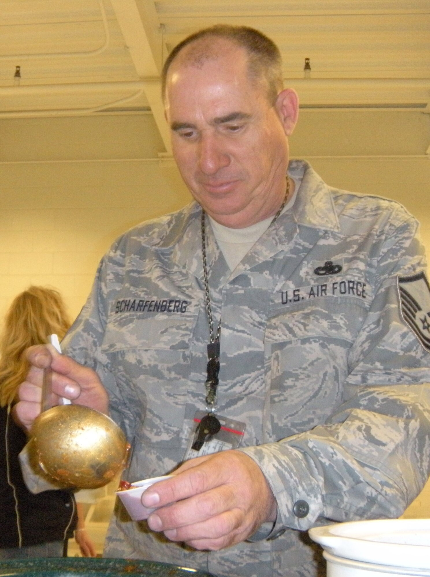 Master Sgt. Rusty Scharfenberg, 302nd Aircraft Maintenance Squadron, tastes chili competitor number five while making the rounds of taste-testing April 1 during the annual 302nd Airlift Wing chili cookoff event at Peterson Air Force Base, Colo. Sergeant Scharfenberg confessed that while he was enjoying the chili samples, he was biased on his choice because of his wife's own chili submission. Located in the 39th Aerial Port Squadron, 18 competitors submitted their green or red chili creations for either a first, second or third place award recognition of "best chili" in their category. For the green chili category: 1st, Master Sgt. David Robbin; 2nd, Senior Master Sgt. Dean Firestein; and 3rd, Mrs. Katie Davidson. For the red chili category: 1st, Master Sgt. Pam Scharfenberg; 2nd, Master Sgt. Richele Beckett; and 3rd, Mr. Russell Dunlap. (U.S. Air Force photo/Staff Sgt. Stephen J. Collier)
