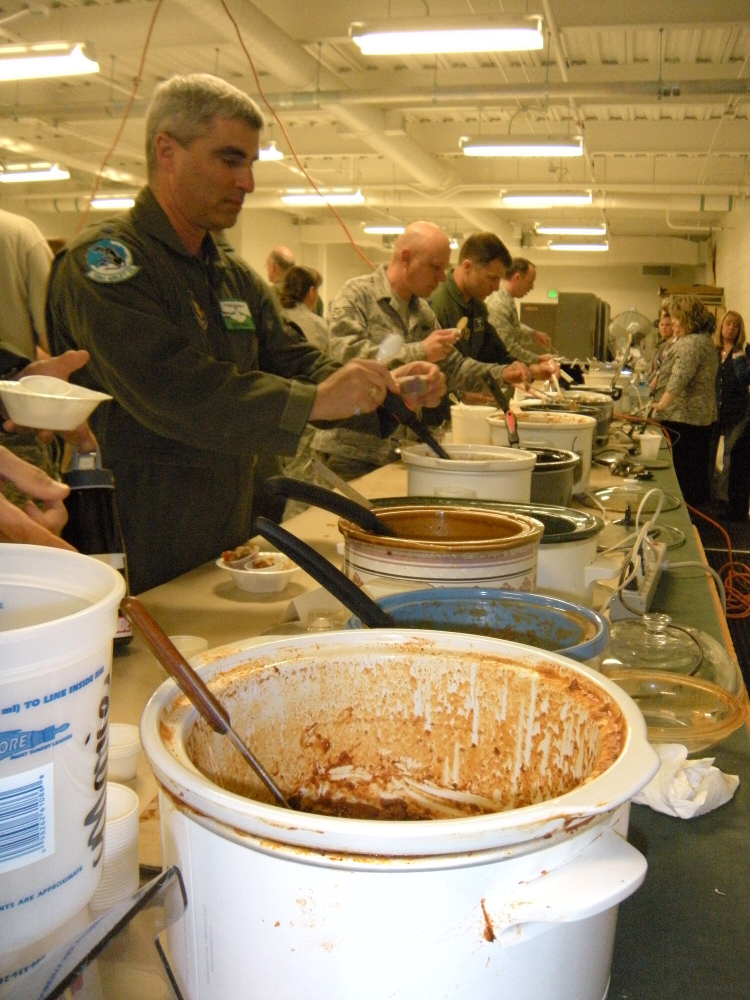Lt. Col. Keith Wesley, 731st Airlift Squadron director of operations, takes on a serving of chili April 1 during the annual 302nd Airlift Wing chili cookoff event at Peterson Air Force Base, Colo. Located in the 39th Aerial Port Squadron, 18 competitors submitted their green or red chili creations for either a first, second or third place award recognition of "best chili" in their category. For the green chili category: 1st, Master Sgt. David Robbin; 2nd, Senior Master Sgt. Dean Firestein; and 3rd, Mrs. Katie Davidson. For the red chili category: 1st, Master Sgt. Pam Scharfenberg; 2nd, Master Sgt. Richele Beckett; and 3rd, Mr. Russell Dunlap. (U.S. Air Force photo/Staff Sgt. Stephen J. Collier)