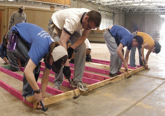 Cadets 3rd Class Kirby Forssell and Chris Miller, Cadet 1st Class Michael Bates and Cadet 3rd Class Paola Gavilanes assemble a wall frame in Bryan, Texas, March 23, 2010. The cadets volunteered to travel to the small Texas town and build homes as part of Alternative Spring Break March 20-26. (U.S. Air Force photo/John Van Winkle)