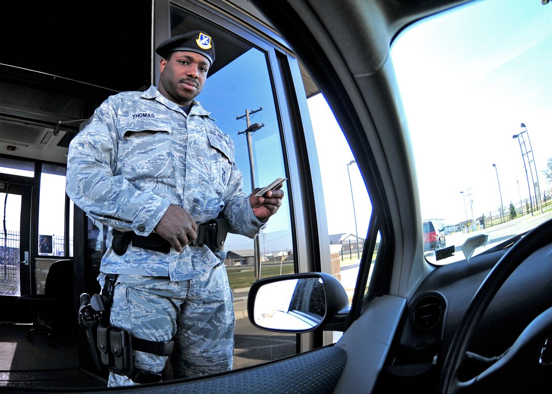U.S. Air Force Staff Sgt. Mahendra Dwight Thomas, checks identification at the main entrance of the Niagara Falls Air Reserve Station, April 2, 2010, Niagara Falls NY. By order of Col. Swartzmiller, effective as of, 29 March 2010, Security Forces will implement 100 percent identification checks on everyone entering the installation. (U.S. Air Force photo by Staff Sgt. Joseph McKee)