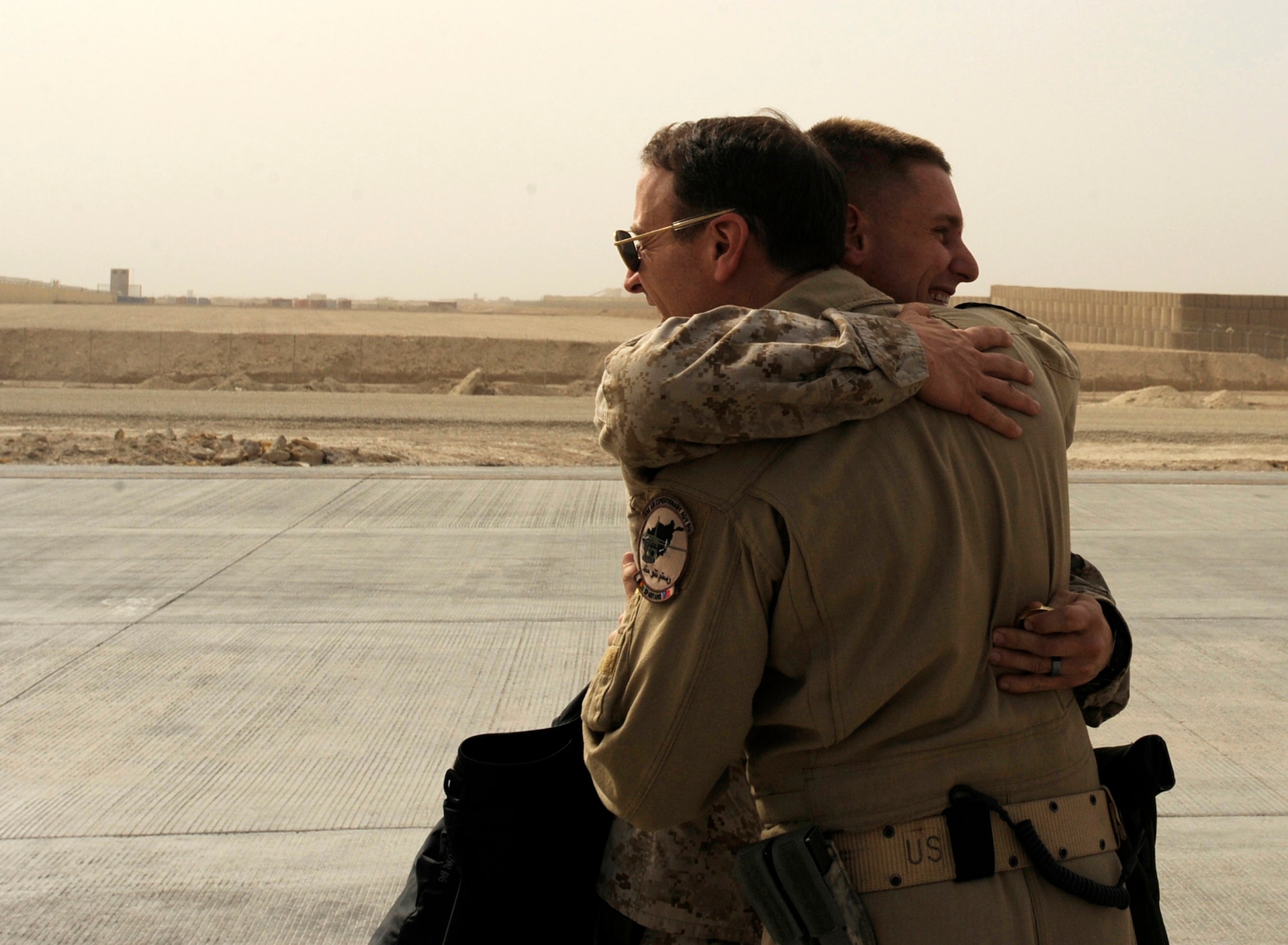 Marine 1st Lt. Benjamin Boera, (left) 5th Battalion 11th Marines High Mobility Artillery Rocket System Tango Battery platoon commander, hugs his dad, Brig. Gen. Michael Boera, 438th Air Expeditionary Wing and Combined Air Power Transition Force commander, March 28, 2010, at Camp Bastion, Afghanistan. It's back to work for the Boera?s after a brief reunion. (U.S. Air Force photo/Staff Sgt. Manuel J. Martinez/released)

