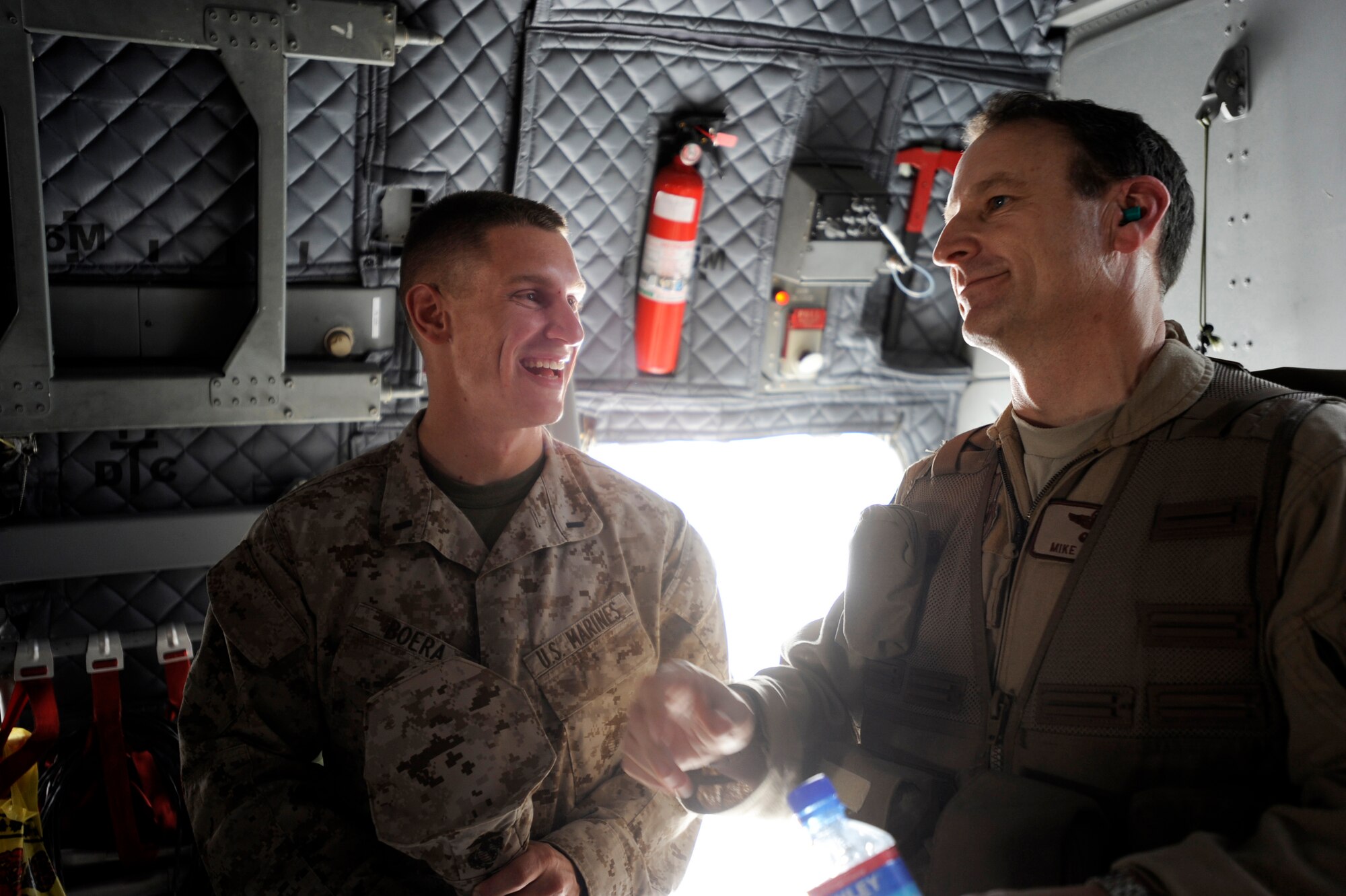 Marine 1st Lt. Benjamin Boera, (left) 5th Battalion 11th Marines High Mobility Artillery Rocket System Tango Battery platoon commander, and his dad, Brig. Gen. Michael Boera, 438th Air Expeditionary Wing and Combined Air Power Transition Force commander, share a laugh aboard an Afghan National Army Air Corps C-27A Spartan March 28, 2010, at Camp Bastion, Afghanistan. General Boera caught up with his son after conducting an International Security Assistance Force mission, transporting weapons and cargo for Afghan National Police and qualifying Afghanistan's first C-27 loadmaster. (U.S. Air Force photo/Staff Sgt. Manuel J. Martinez/released)