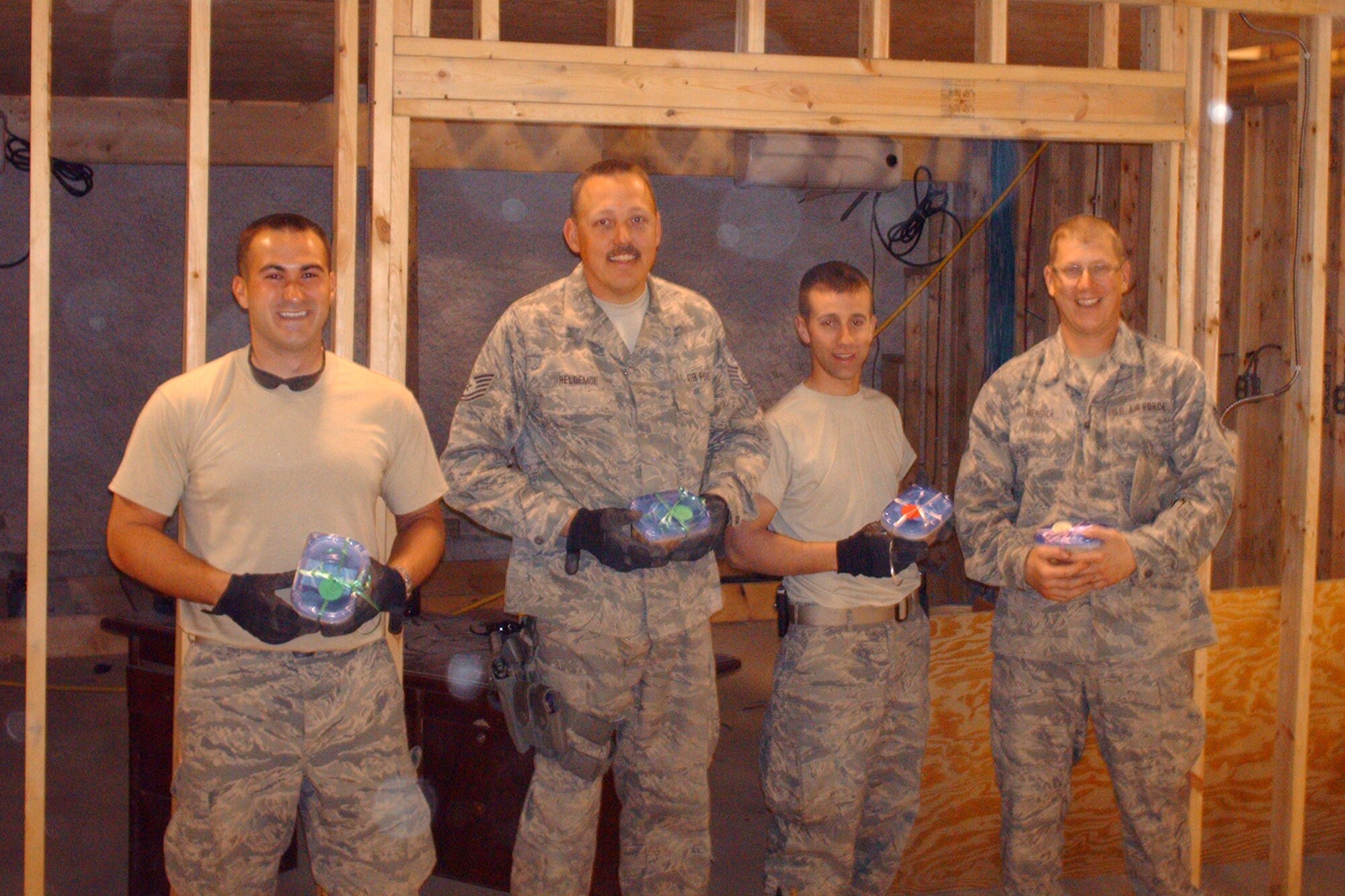 148th Fighter Wing Civil Engineer members from Duluth, Minn., stationed at Bagram Air Field, Afghanistan, proudly show off the cookies they have received from the Cookie Brigade March 2010.
