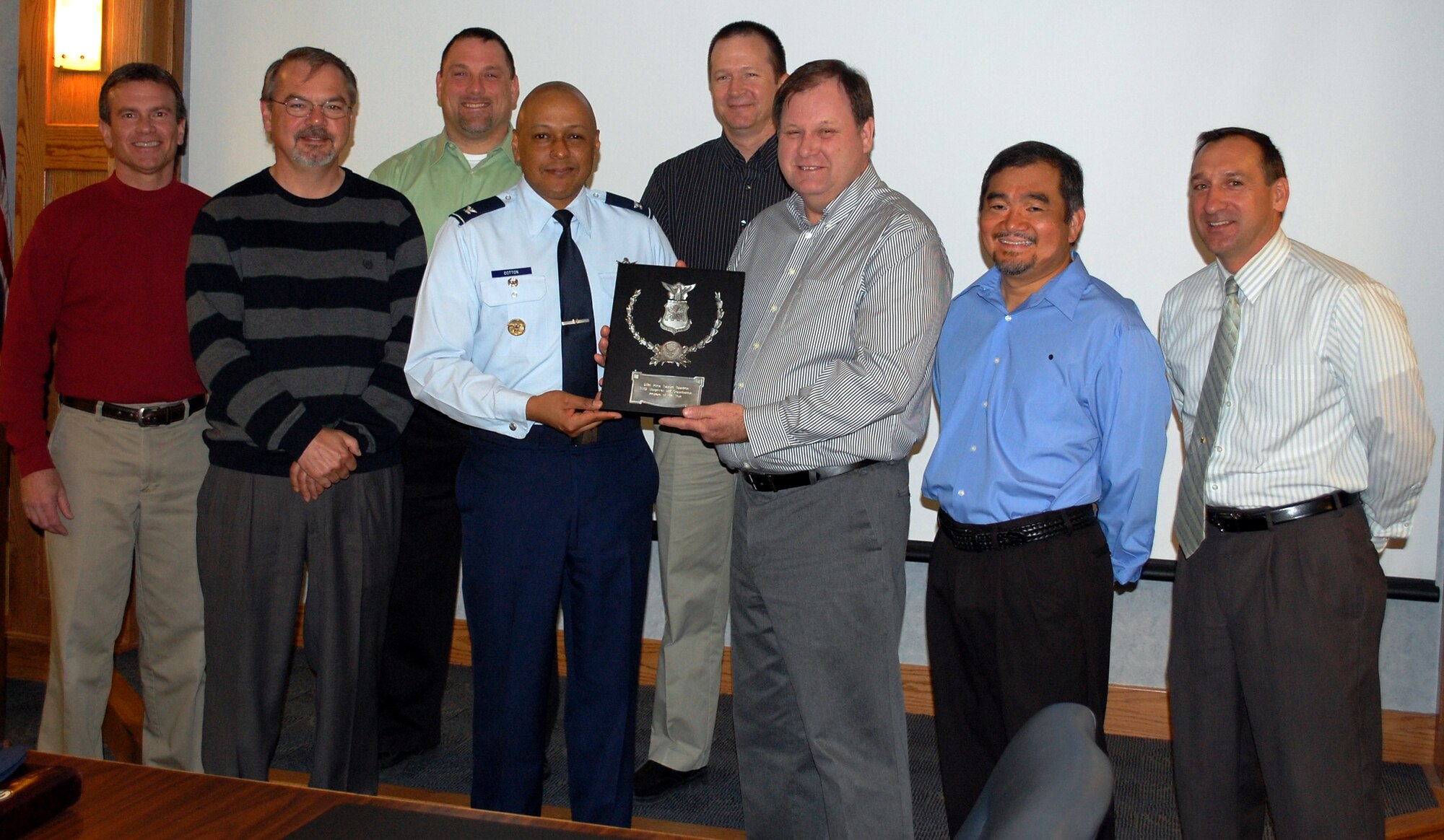 The 341st Force Support Squadron Manpower Office was selected for the 2009 Air Force Level Manpower and Organization of the Year Award. Picture here with Col. Anthony Cotton, 341st Missile Wing vice commander, are the members of the team. Left to right, Troy Larkey, Randy Glick, Paul Finco, Ken Sylva, Kelly Helms, Ed Lara and Brian Jolly. Not pictured is Staff Sgt. Joelle Ellingson. According to Mr. Helms, their jobs basically come down to them being involved in everything that happens in the wing. It more than just manpower, it's every new program, office reduction, deacirvation, merger, test trial, requirements and authorizations, base construction and the list goes on.  (U.S. Air Force photo/2nd Lt. Marshel Slater)