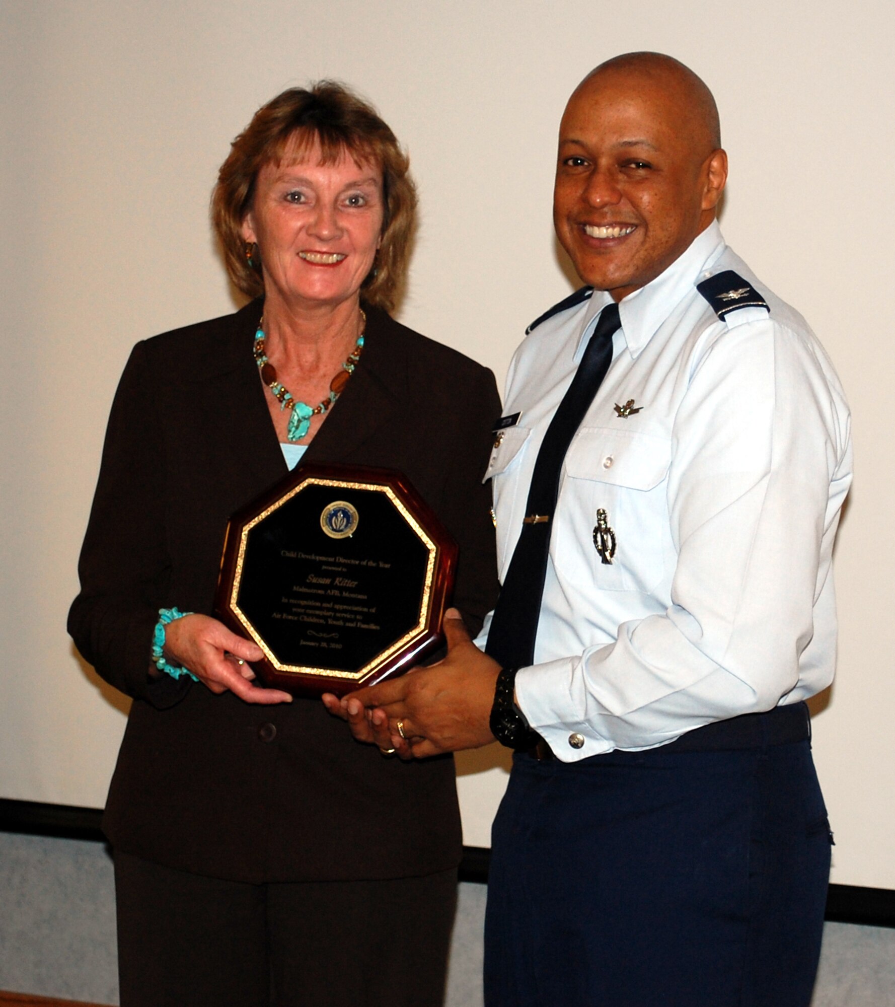 Col. Anthony Cotton, 341st Missile Wing vice commander, presents Susan Ritter, 341st Force Support Squadron with the Air Force-level Child Development Center of the Year Award. Her vigilanec in adhering to accreditation compliance standards, skill in financial managment and successful execution of measures to enhance and improve her facilities are some of the reasons for her selection. (U.S. Air Force photo/2nd Lt. Marshel Slater)