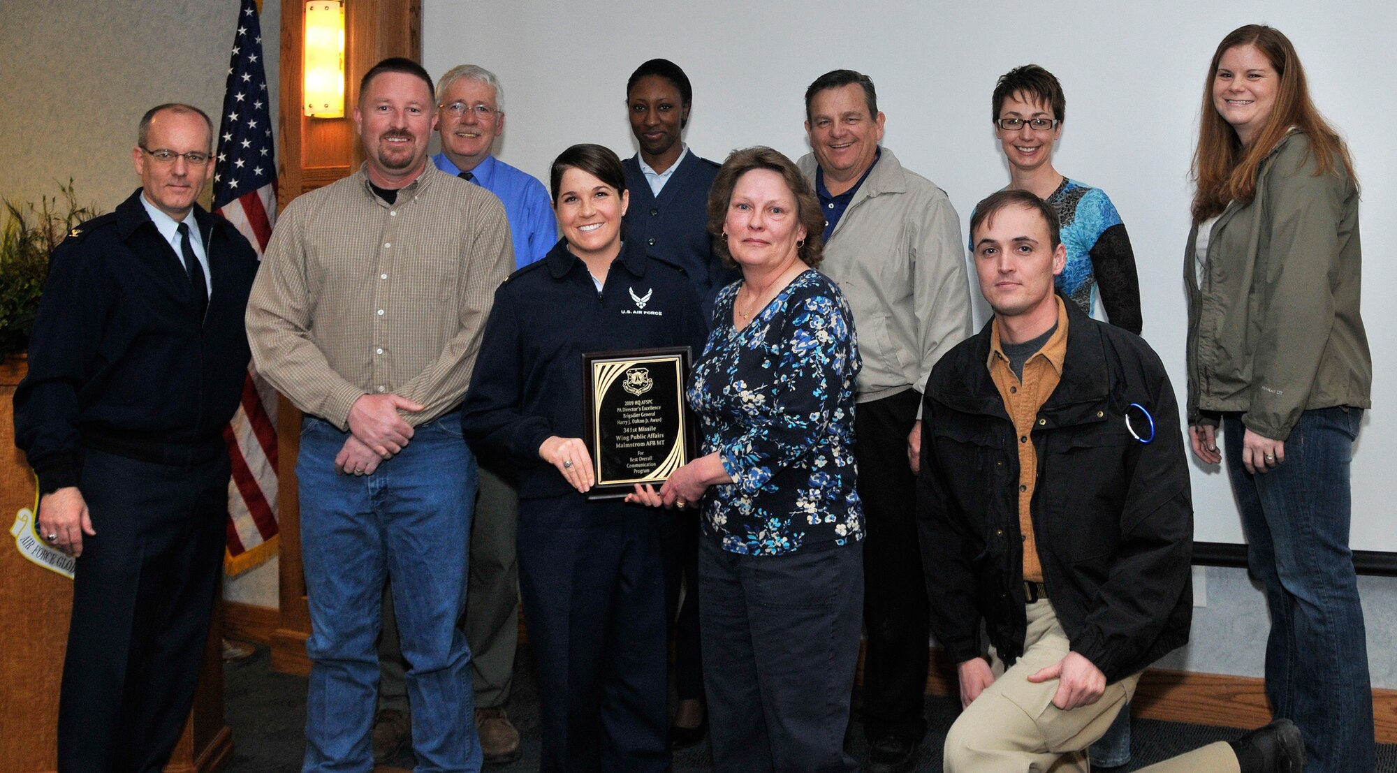 Col. Michael Fortney, 341st Missile Wing commander, poses with members of the 341st Missile Wing Public Affairs Office after presenting them with their third consecutive Brig. Gen. Harry J. Dalton, Jr. Award for Communication Excellence as the best PA office in the command. Picture with Colonel Fortney from left to right, front row, Beau Wade, 2nd Lt. Marshel Slater, Valerie Mullett, John Turner. Back row, left to right, Charlie Heit, Airman 1st Class Kristina Overton, Bob Stillwell, Jessica Buxbaum and Christy Mason. (U.S. Air Force photo/Tech. Sgt. Maritza Mueller)