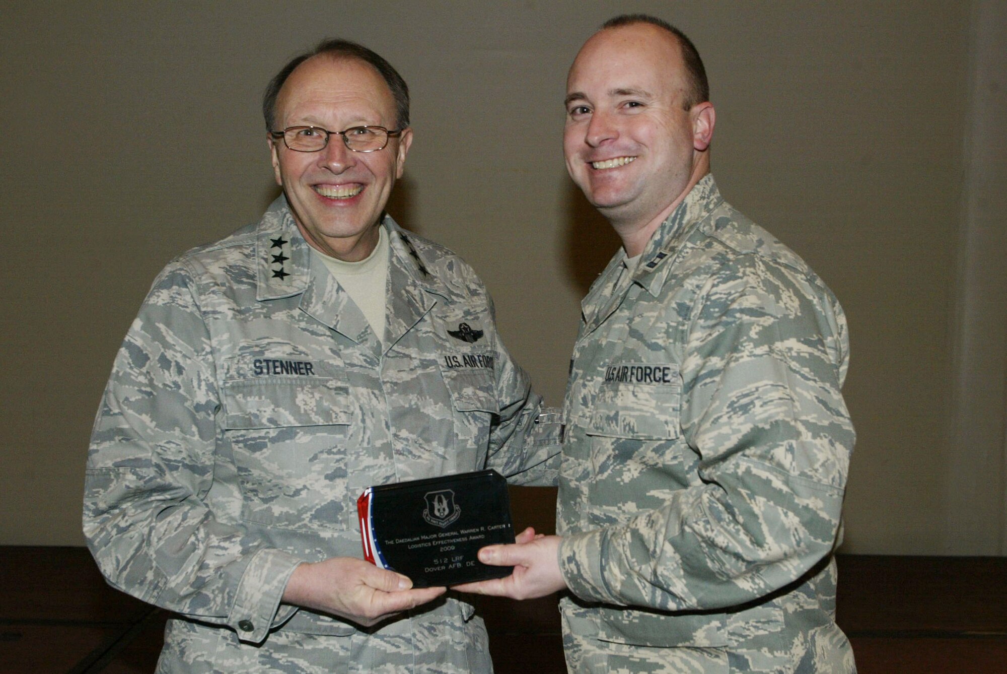 On behalf of Lt. Col. Gretchen Kurlander, 512th Logistics Readiness Flight commander, Capt. Christopher Sweet (right), 512th LRF, accepts the 2010General Carter Daedalian Award as the best logistics readiness unit in Air Force Reserve Command from Lt. Gen. Charles E. Stenner Jr., AFRC commander.The honor was presented in February at the Air Reserve Component Air Transportation and Logistics Readiness Officer Conference in Atlanta. (U.S. Air Force photo/Donald Peek)